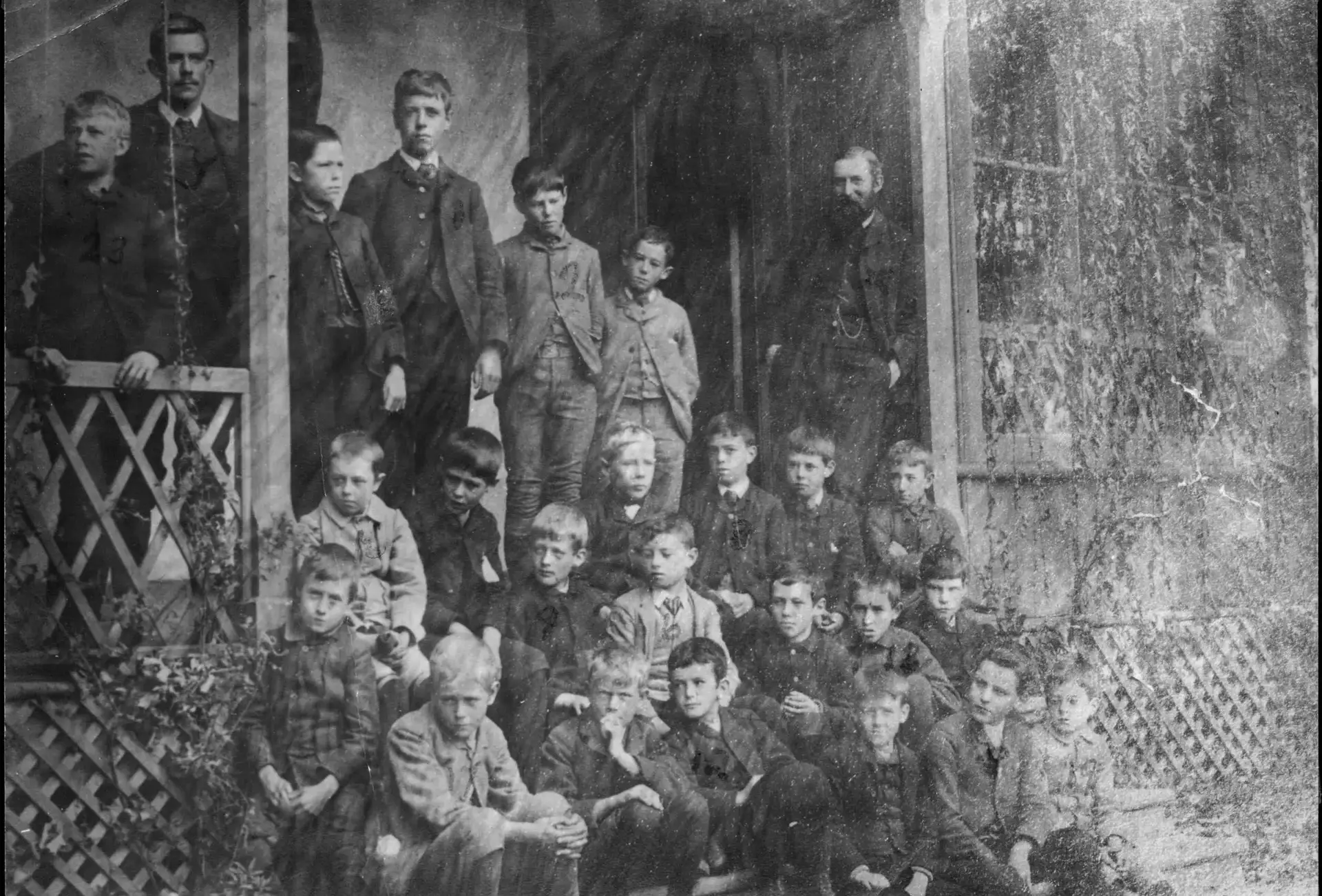 Archival photograph of students sitting on porch