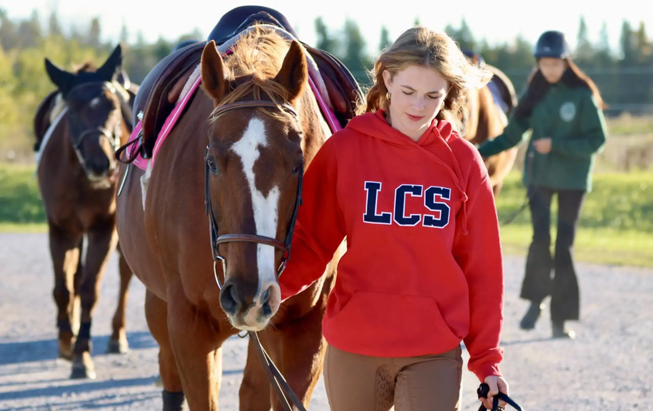 Student leading horse by bridle