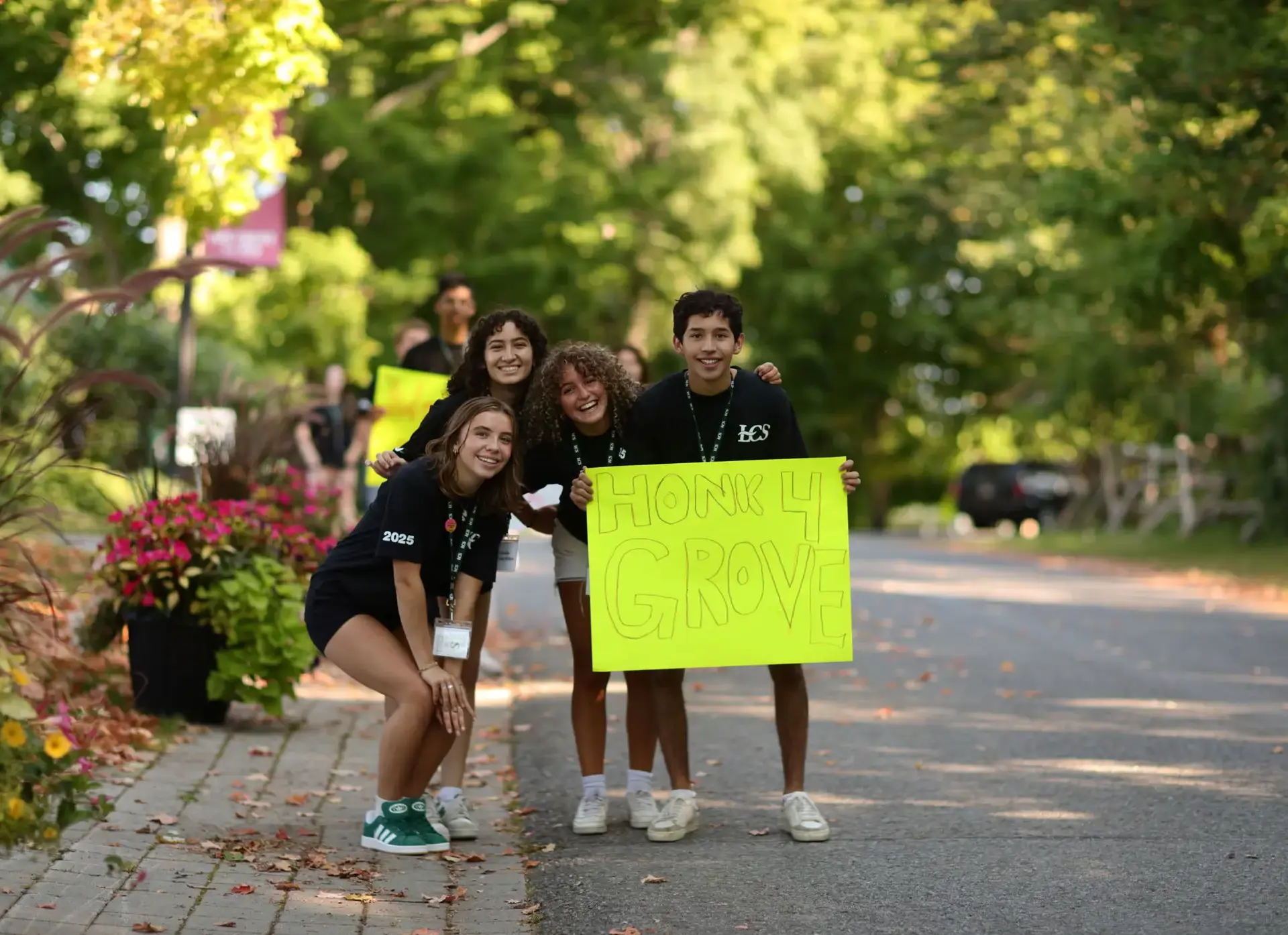 Students holding up sign at admissions event