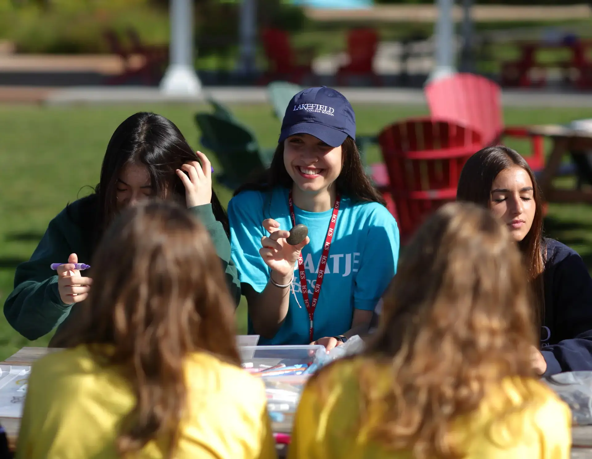 Students sitting at picnic bench during admissions event