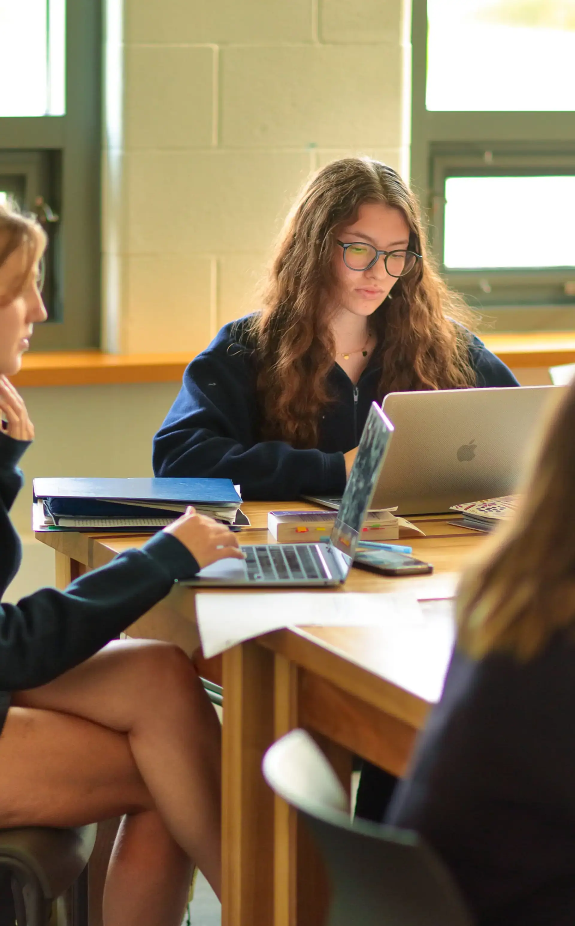 Three students working together collaboratively at table