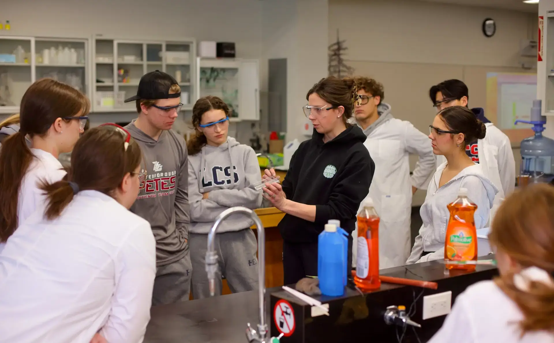 Students watching teacher give demonstration in science lesson