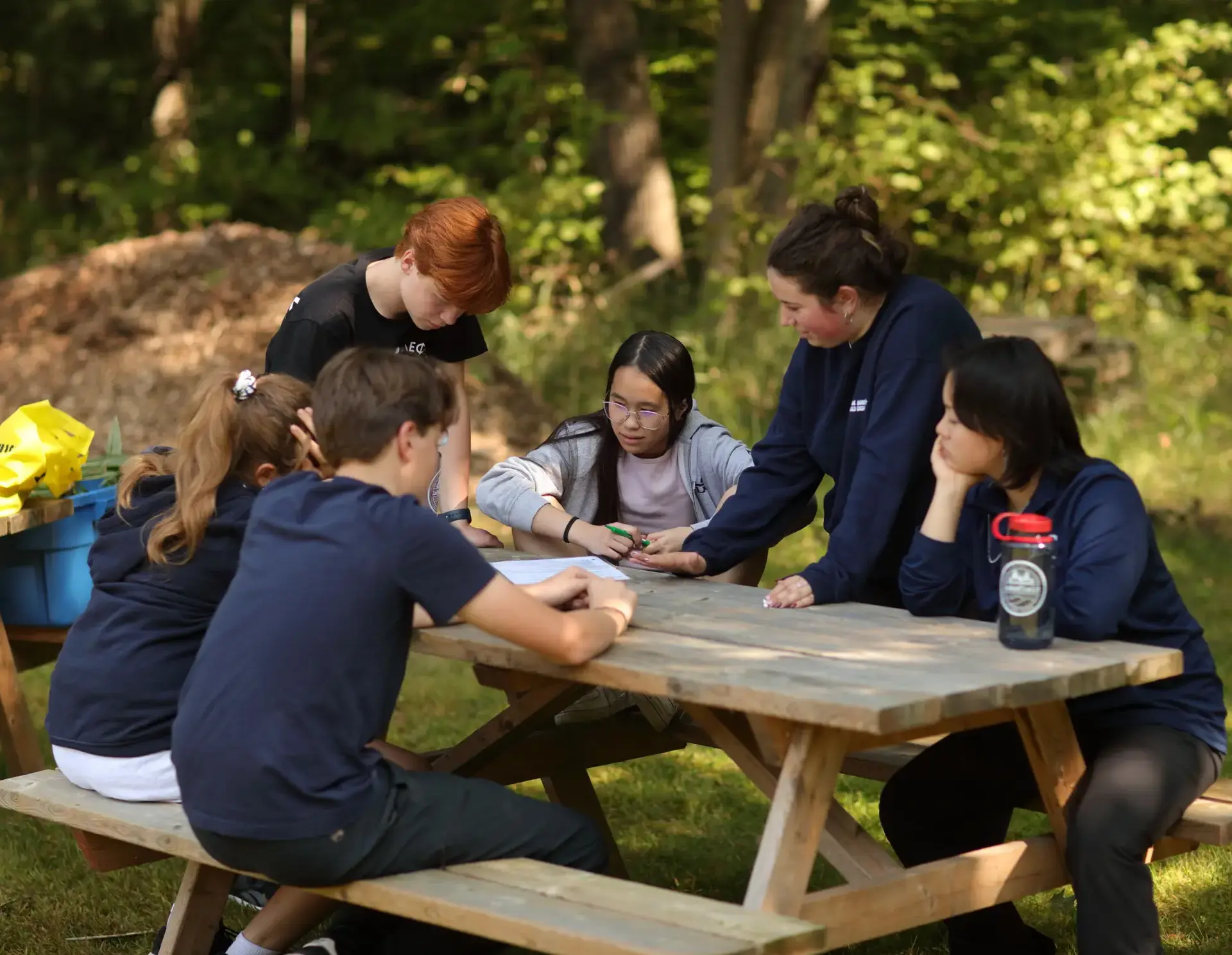 Students chatting together at picnic table