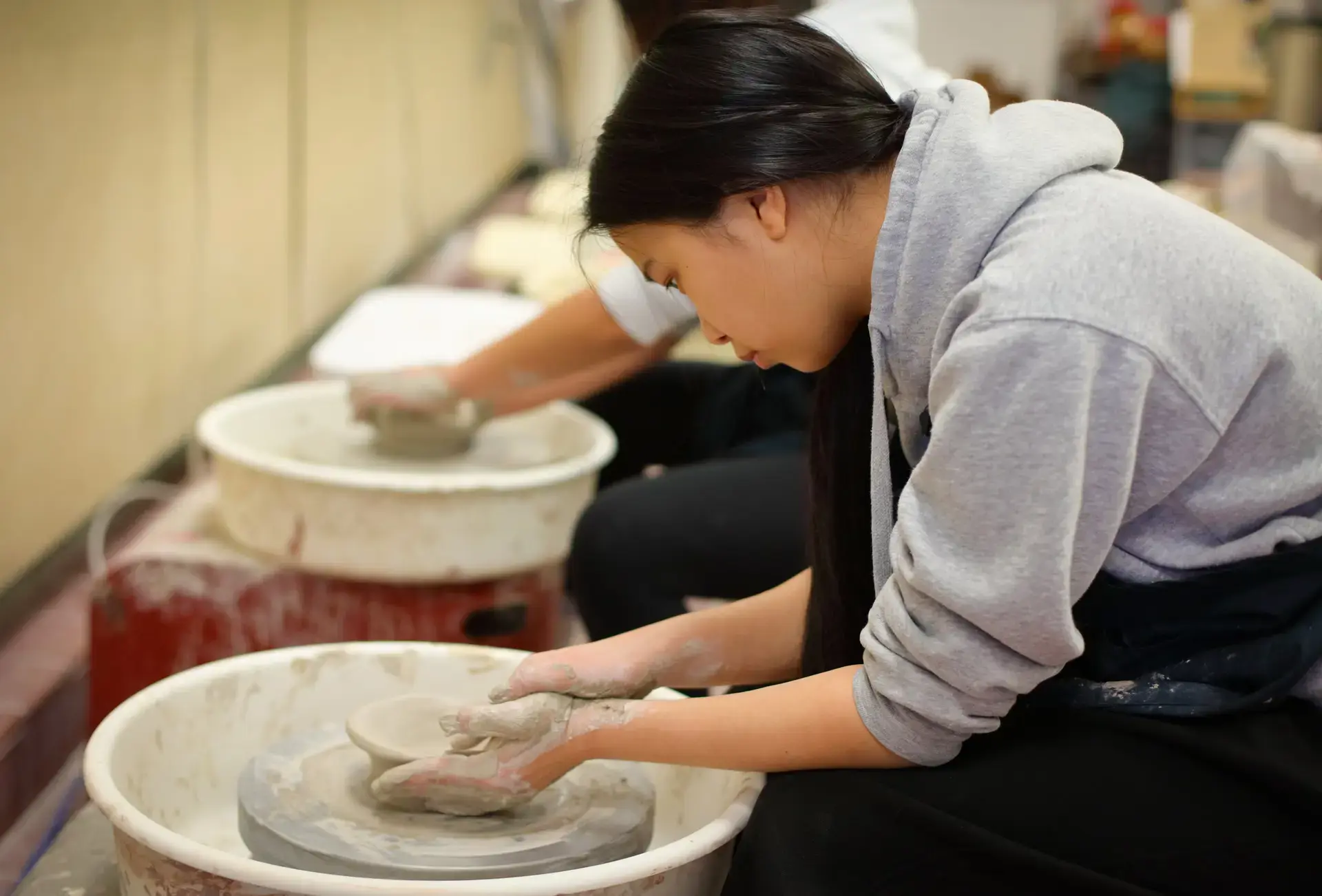Students at pottery wheels