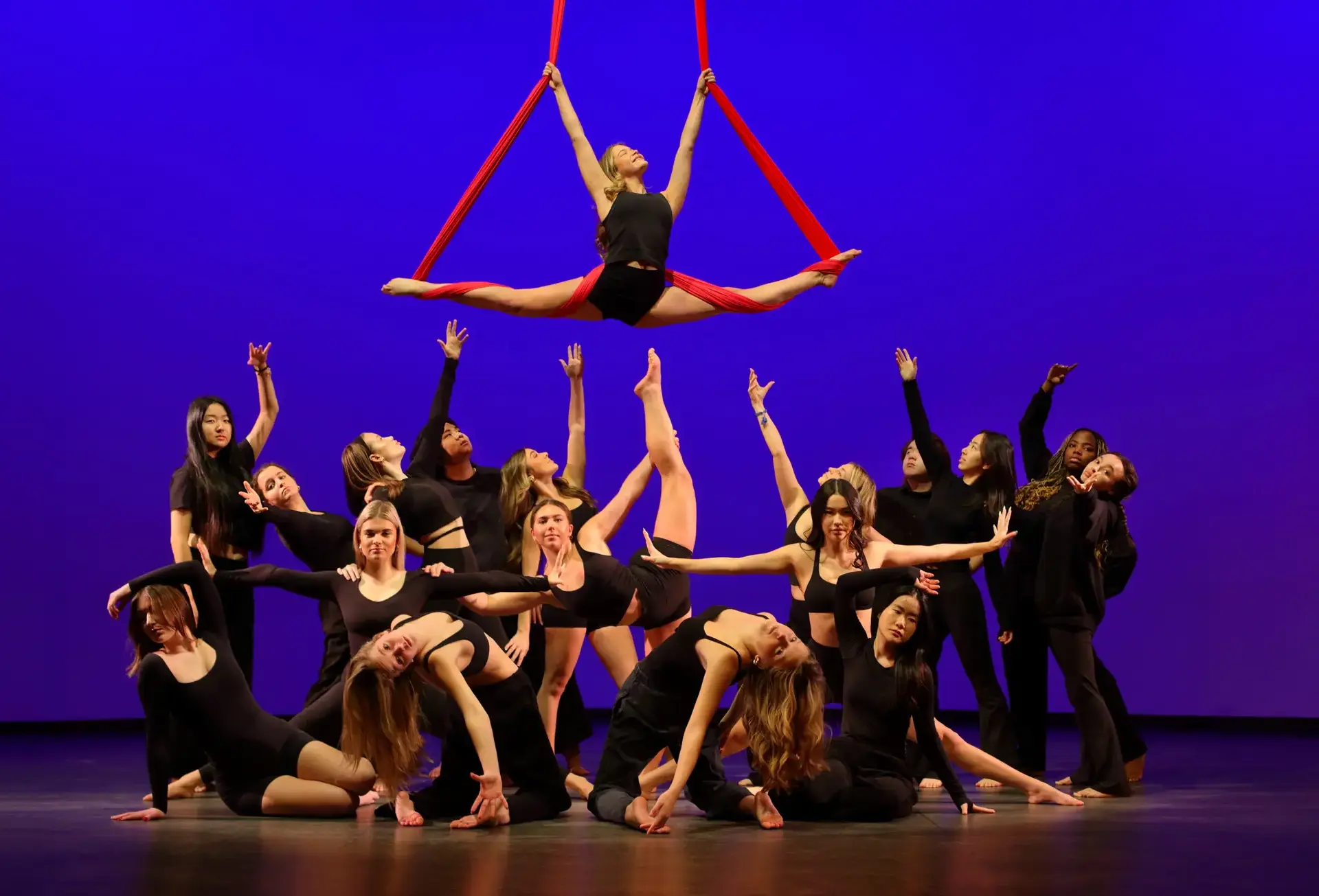 Student dancers performing with silks on stage