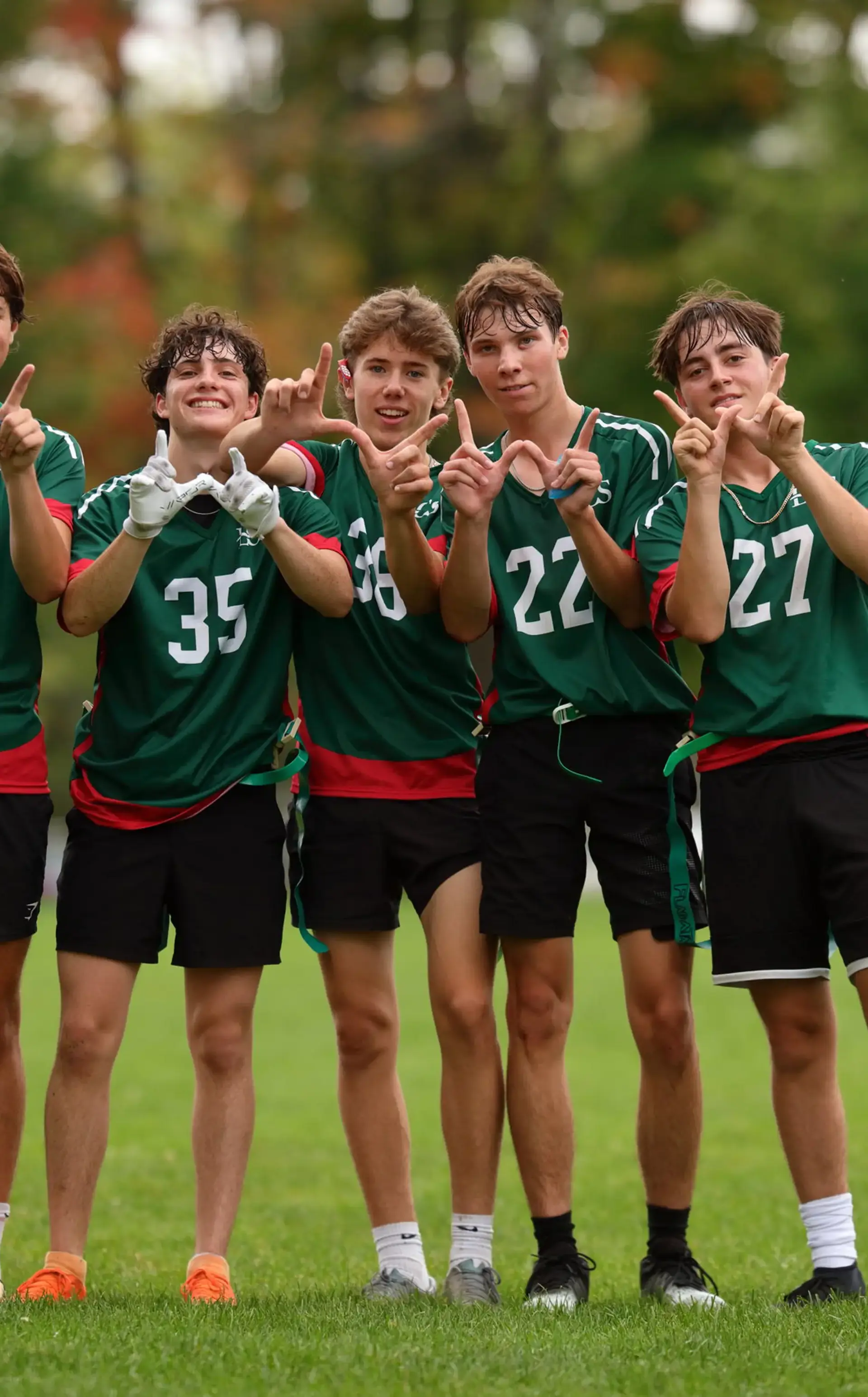 Student athletes making 'W' signs with their hands