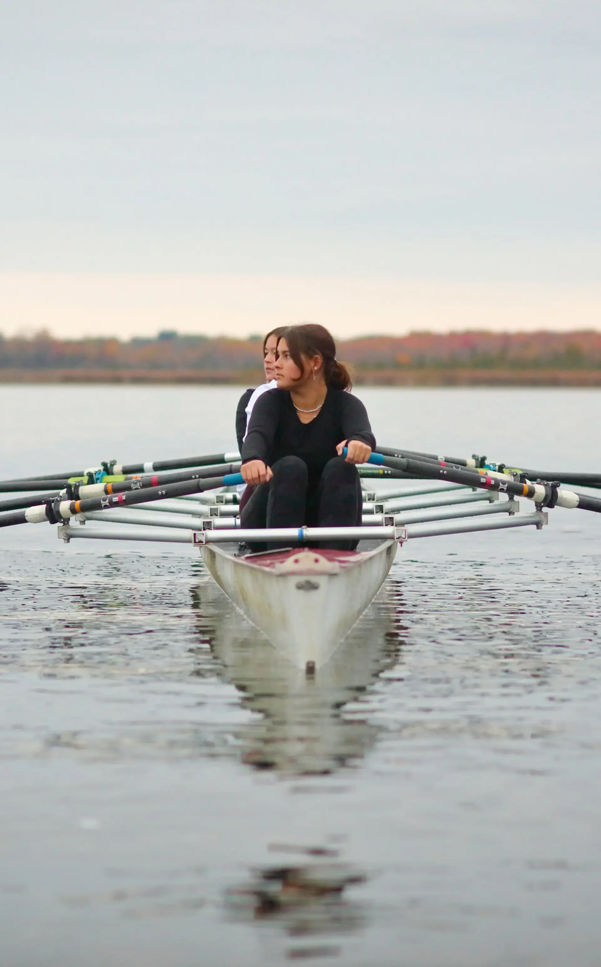 Students rowing on lake