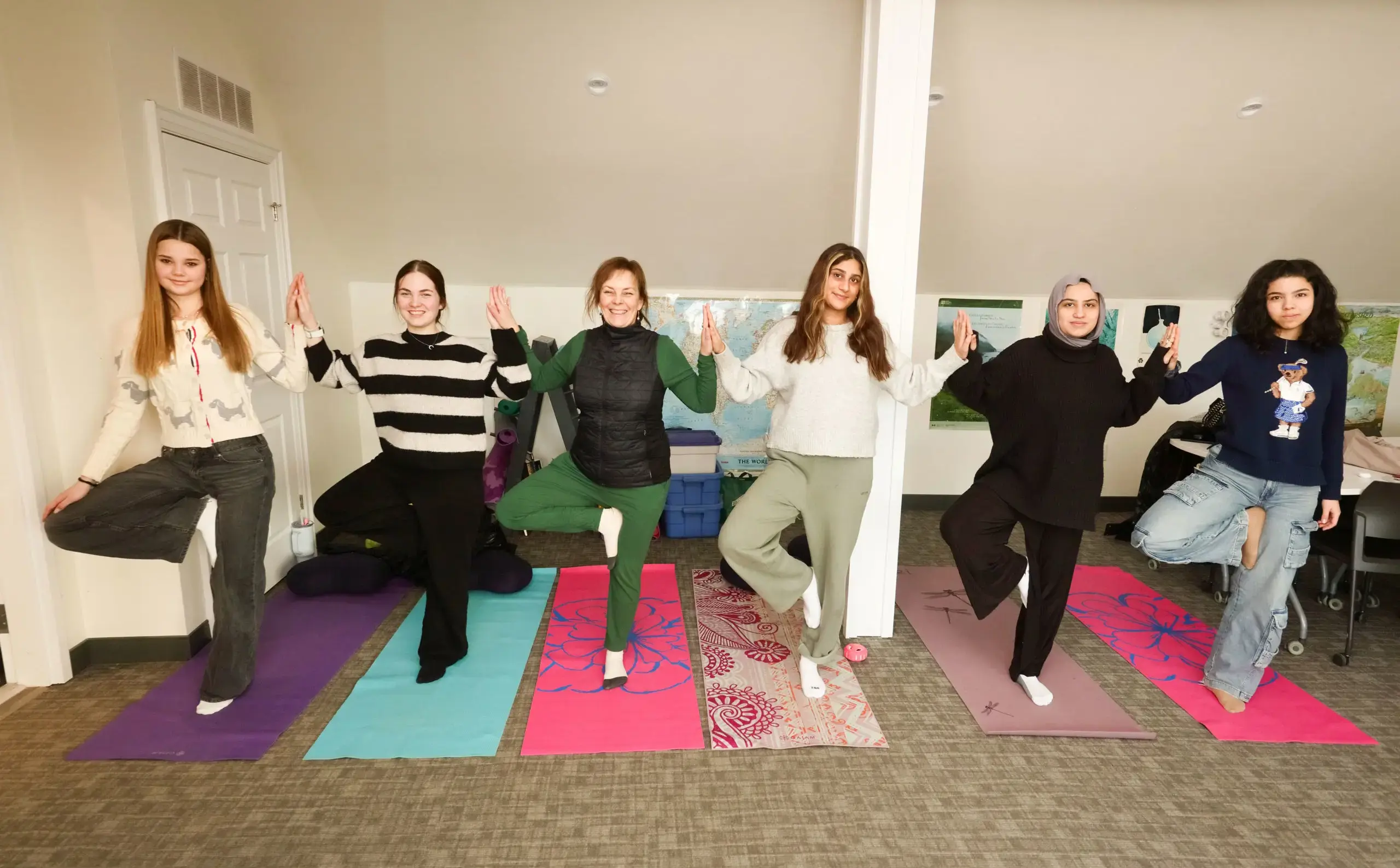 Students standing on yoga mats