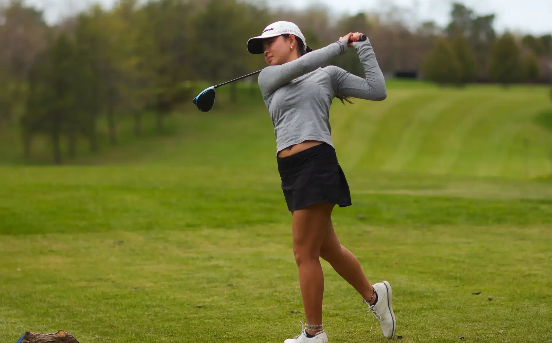 Student golfing
