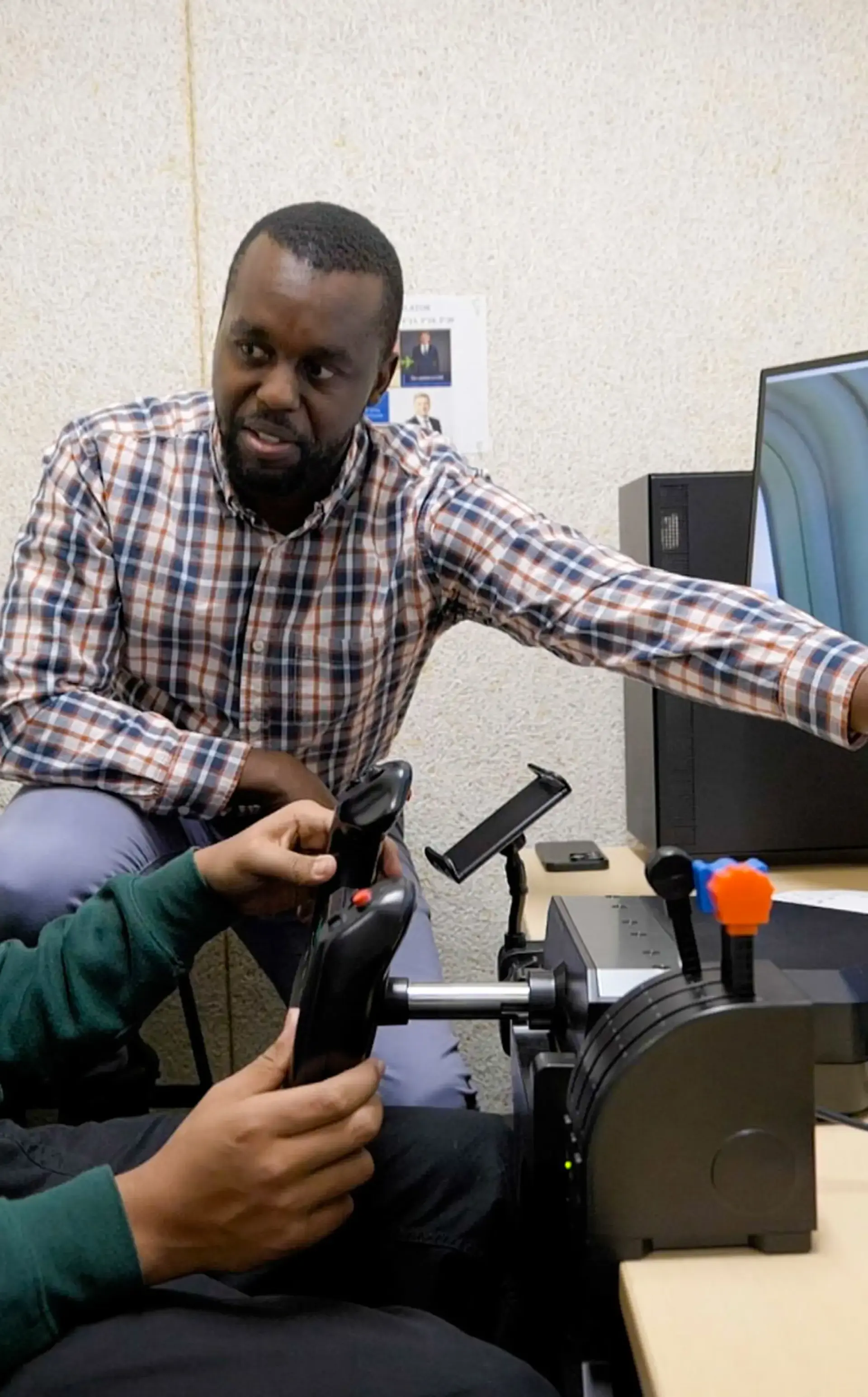Teacher pointing at PC running Flight Simulator