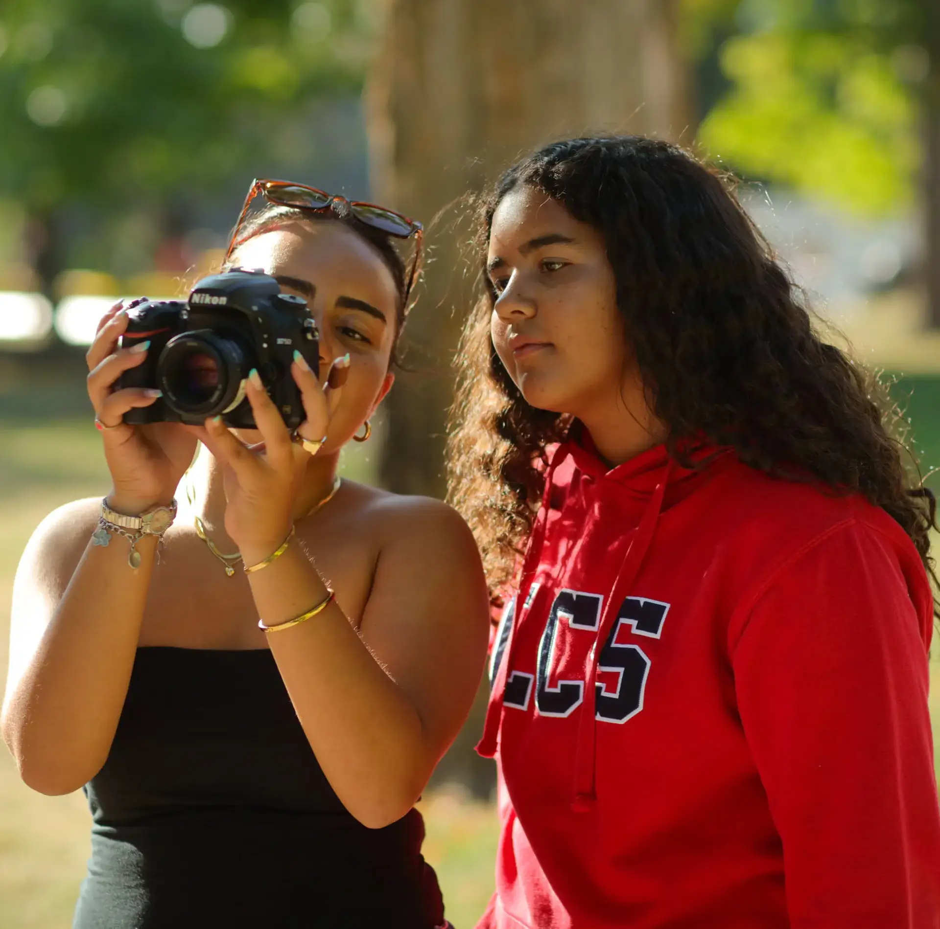 Student photographers looking through viewfinder