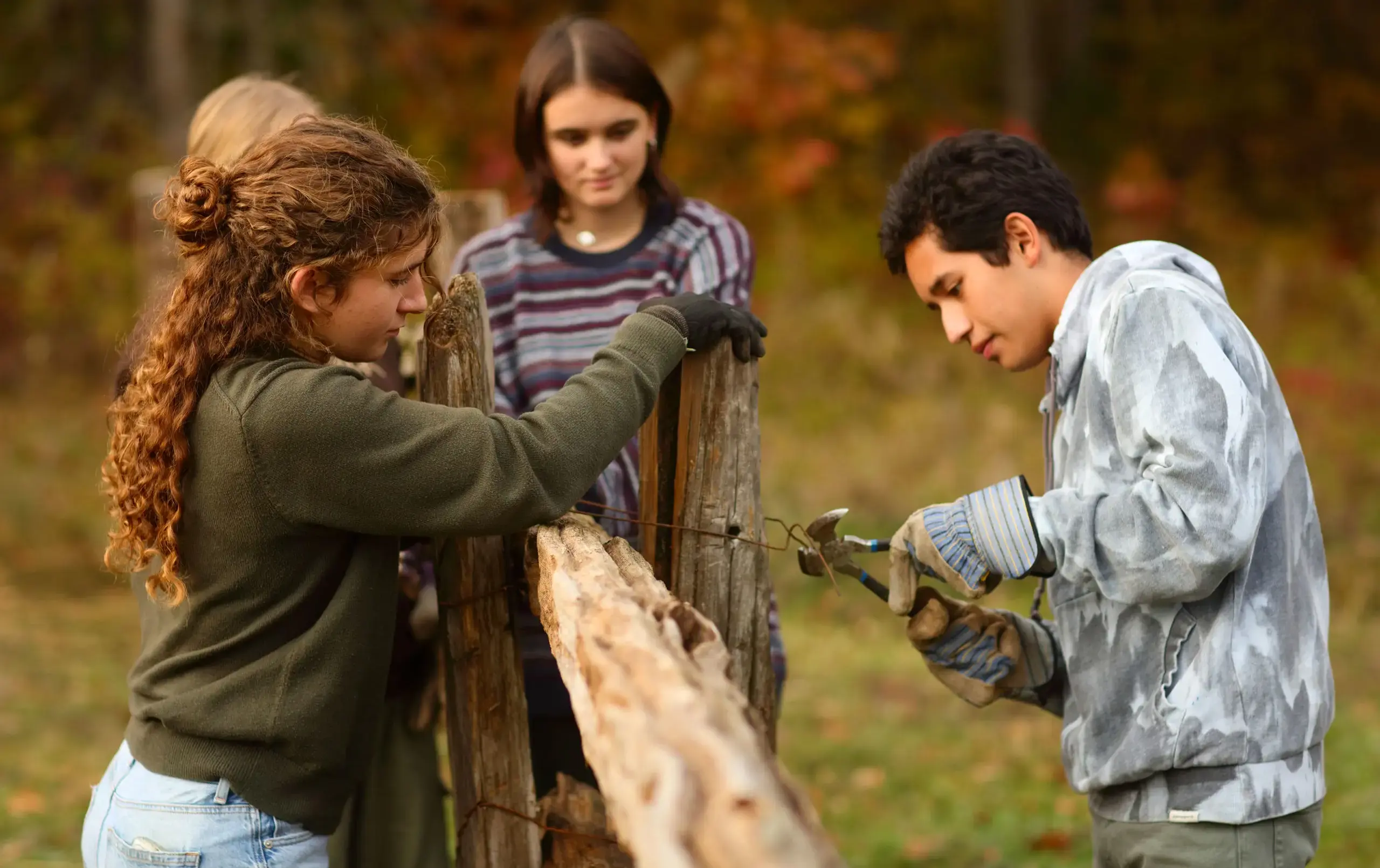 Students during service learning fixing a fence