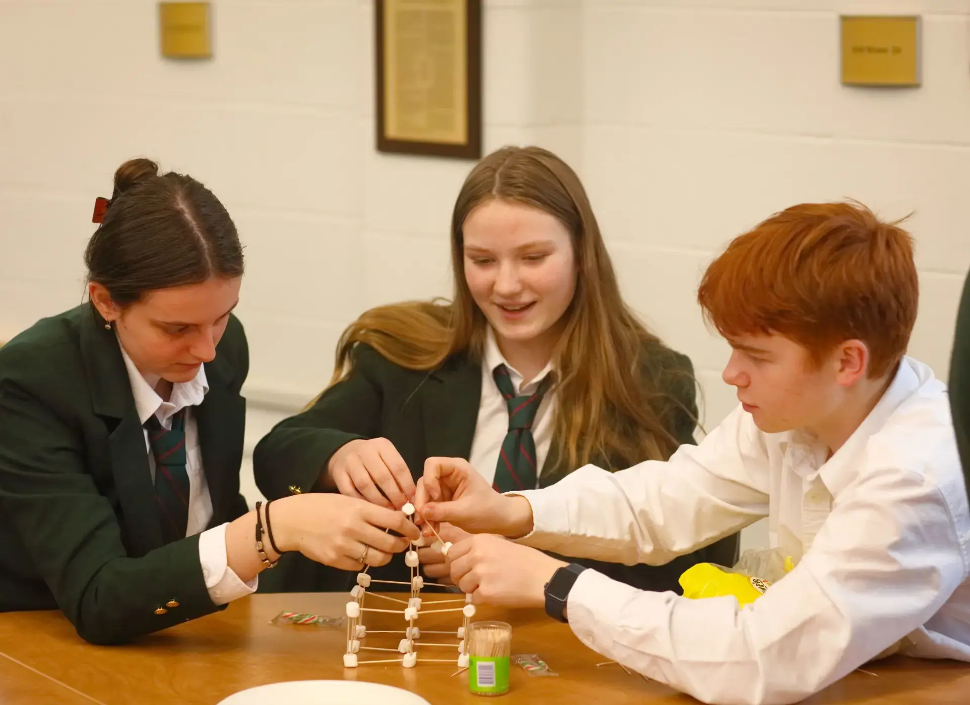 Three students working together collaboratively at table
