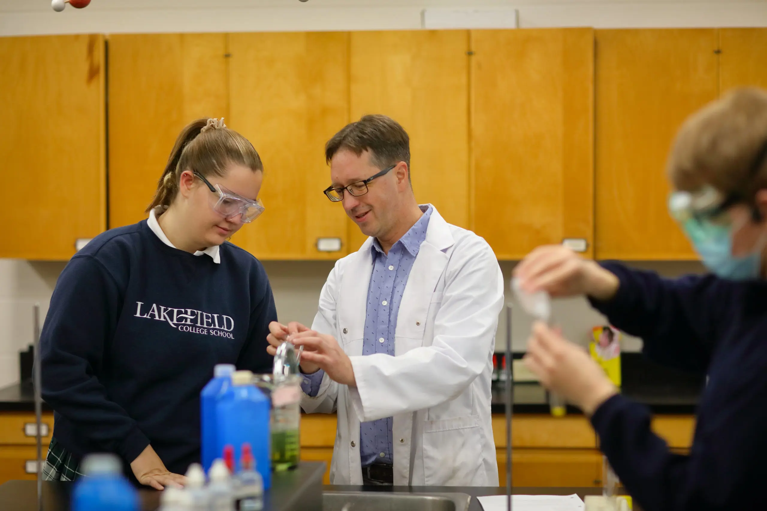 Students examining papers on large table