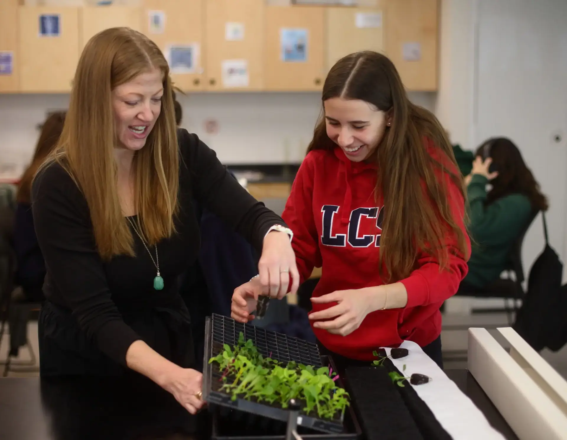 Students interacting with plants in science lesson