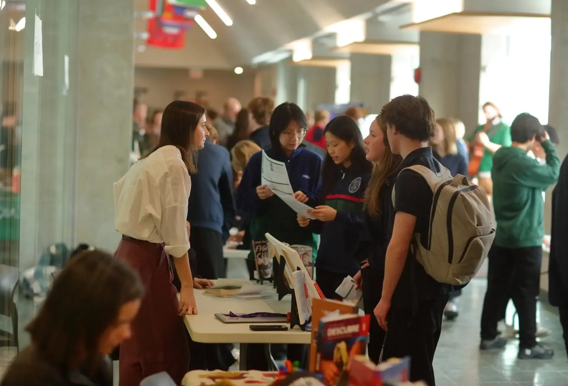 Students interacting with table staff