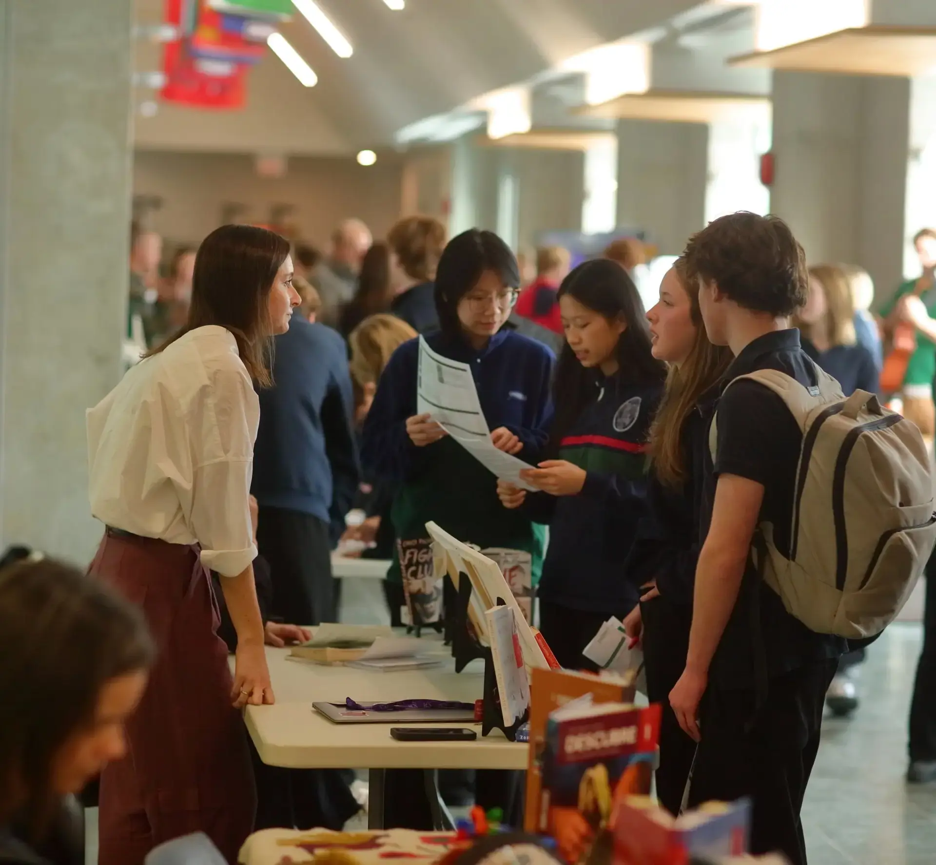 Students speaking to vendor at universities fair