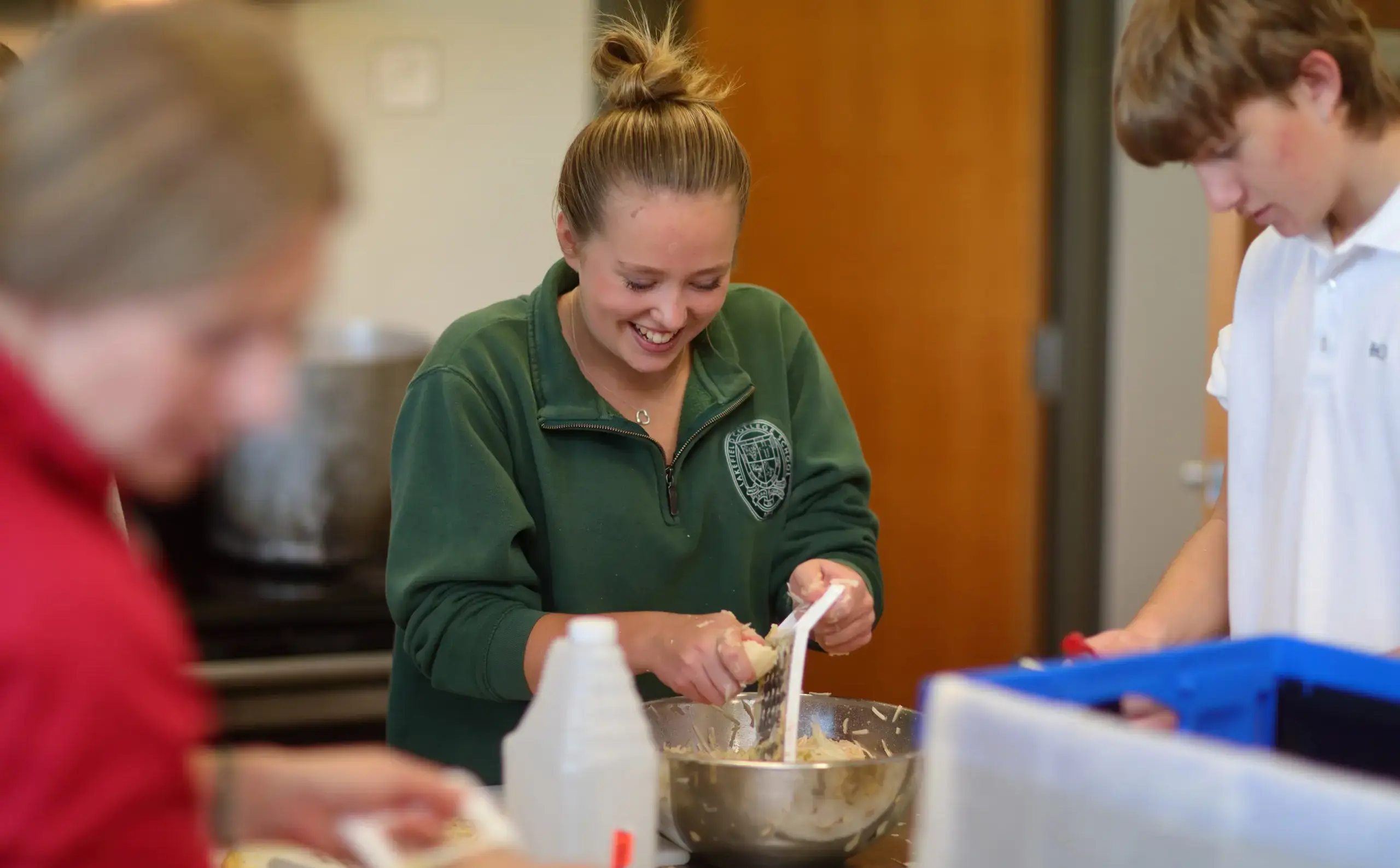 Students laughing during lesson in kitchen