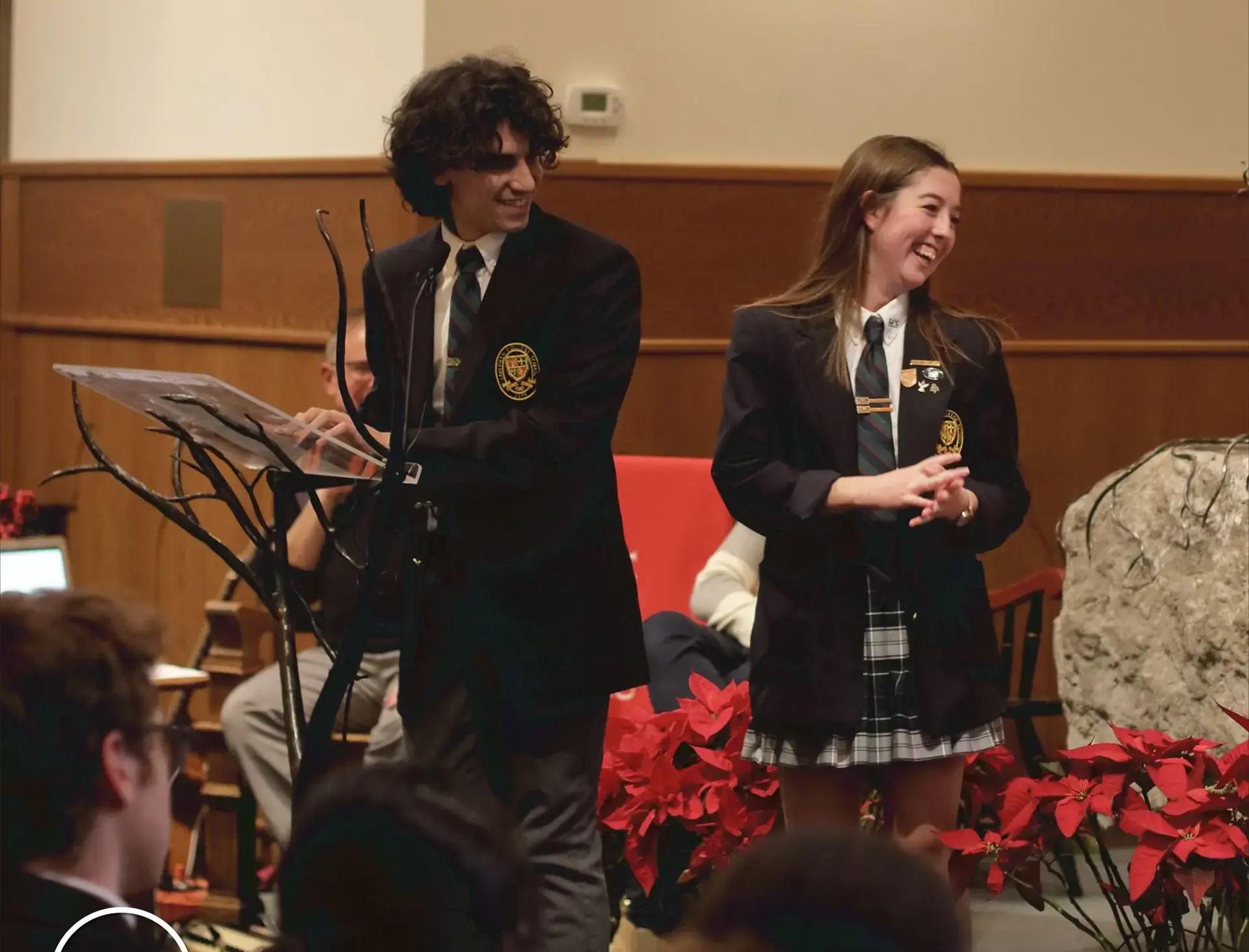 Students standing at lecturn in chapel