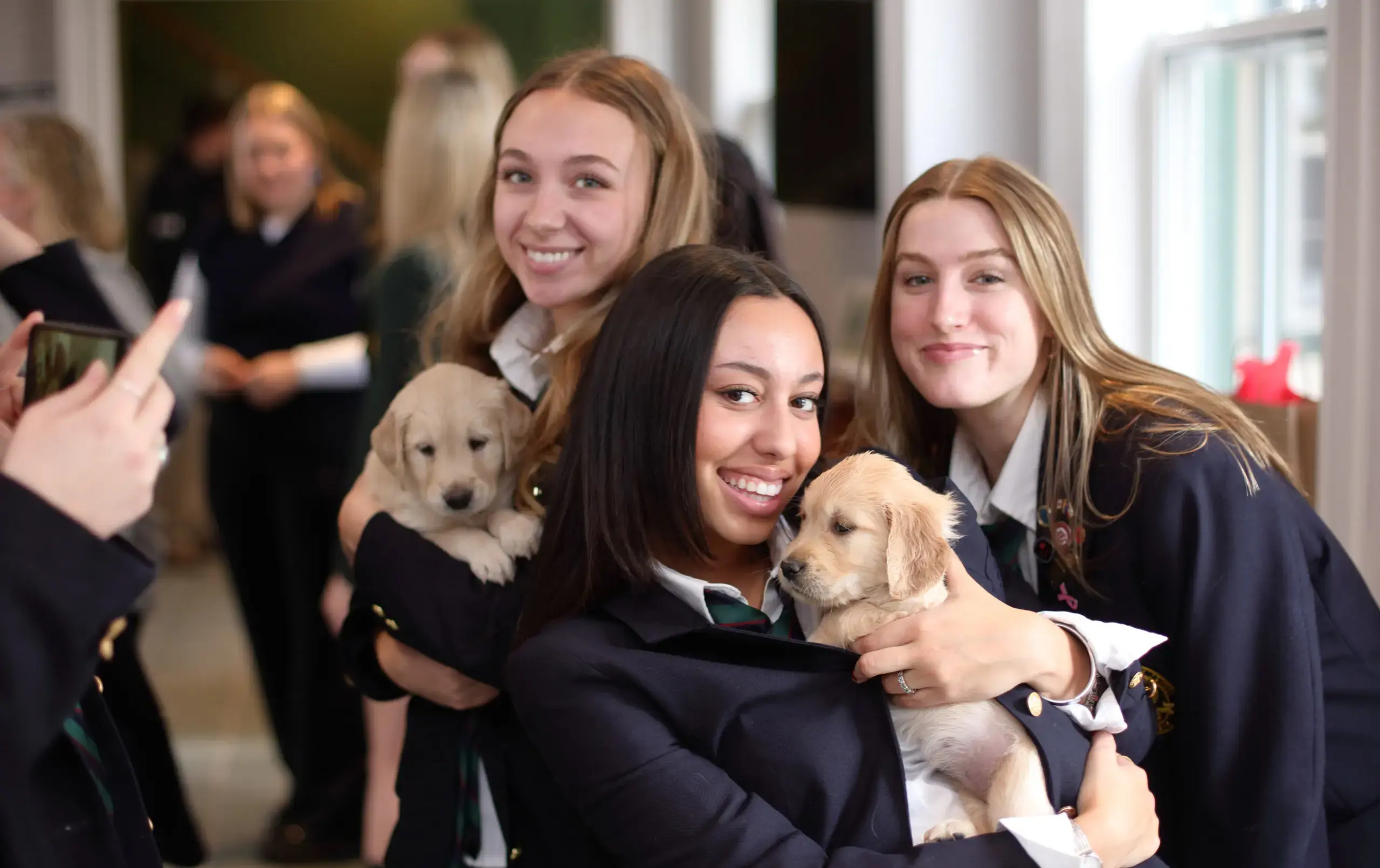 Students holding puppies