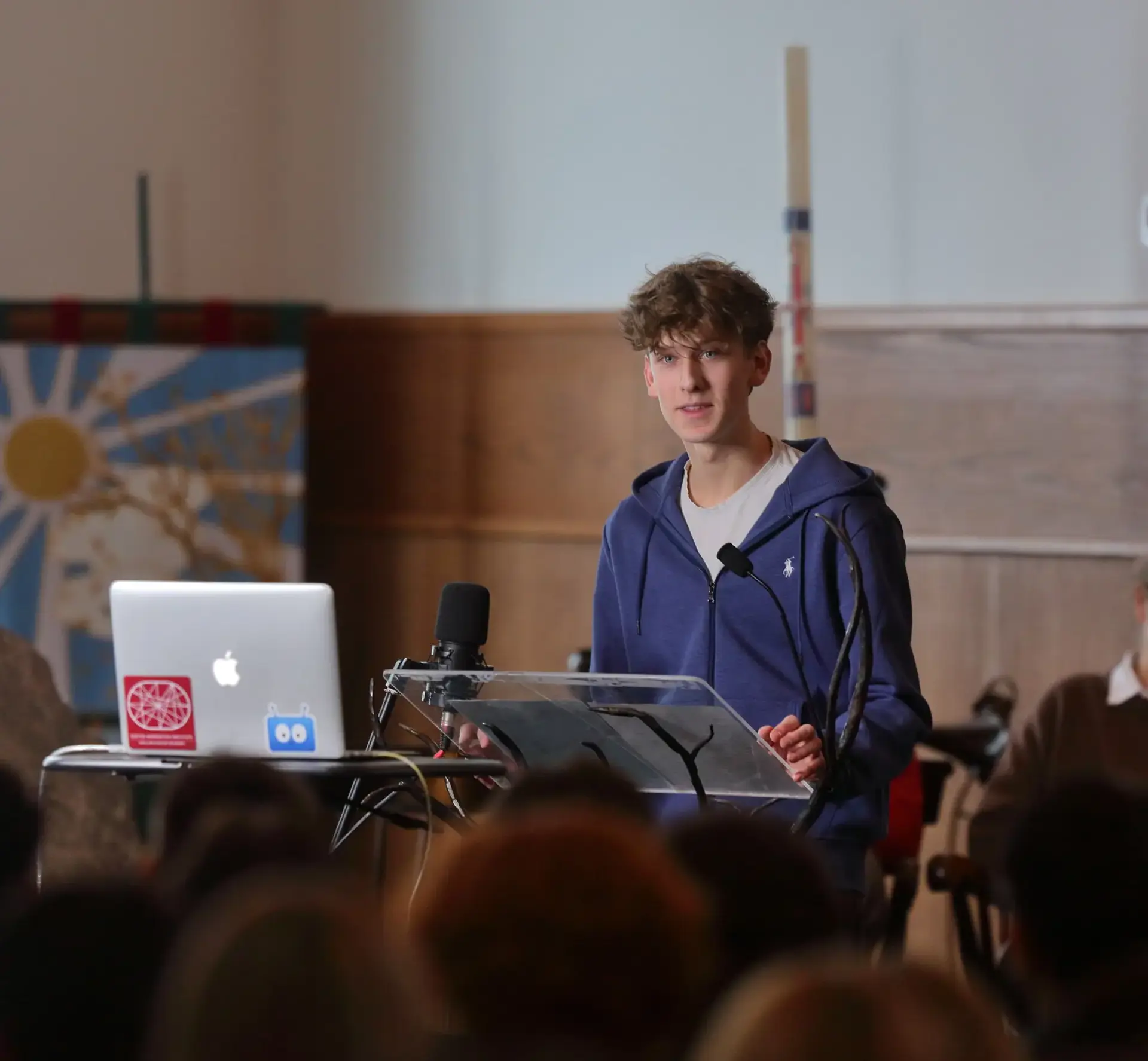 A candid shot of a student delivering a speech during a chapel service.