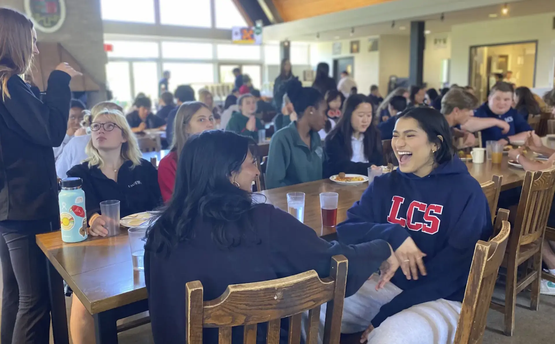 Students chatting and laughing in canteen