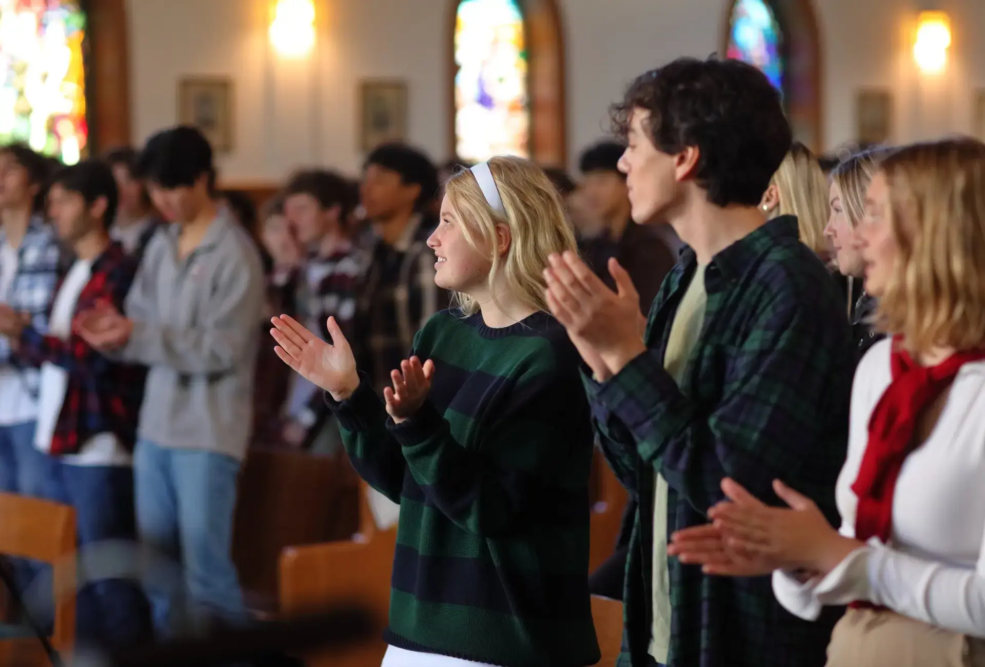 Students applauing in chapel