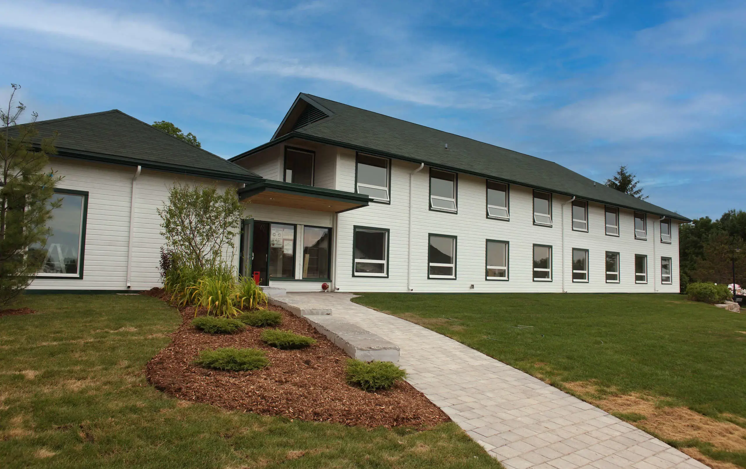 Exterior of Cooper House, a two-storey building with large windows