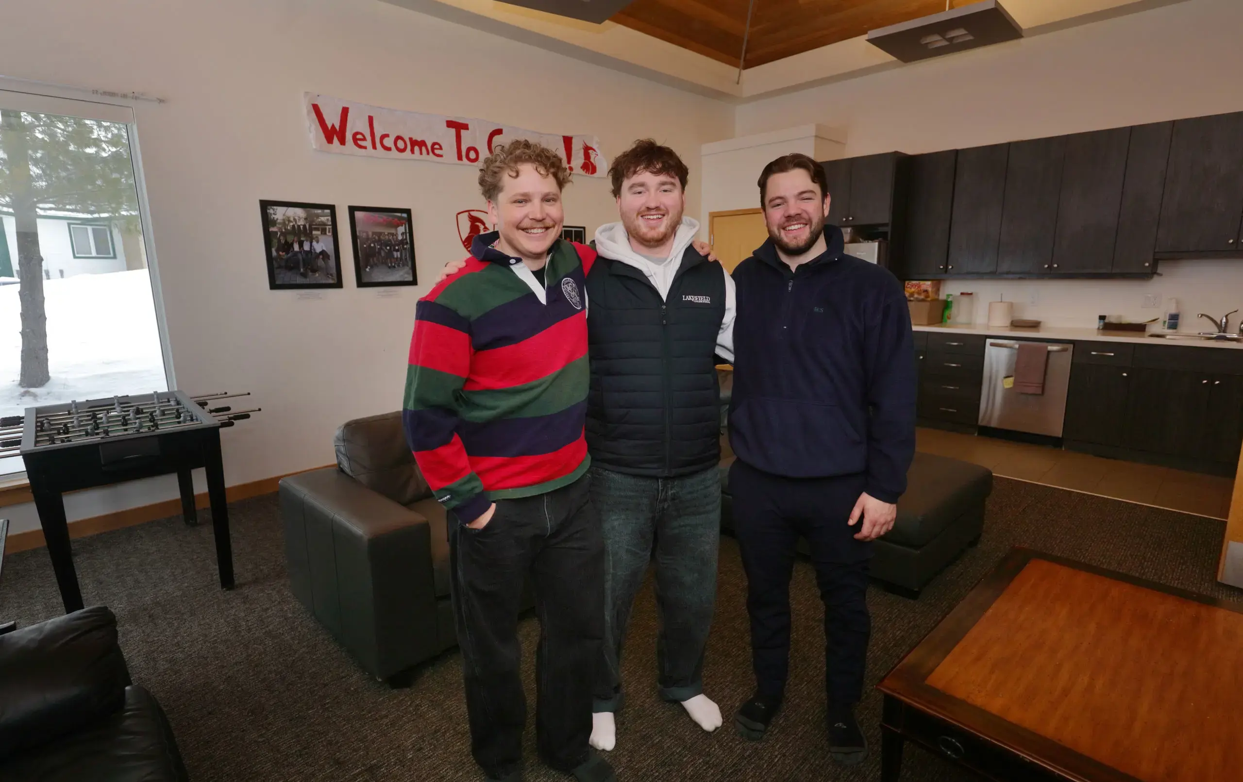 Three Cooper House team members in common area