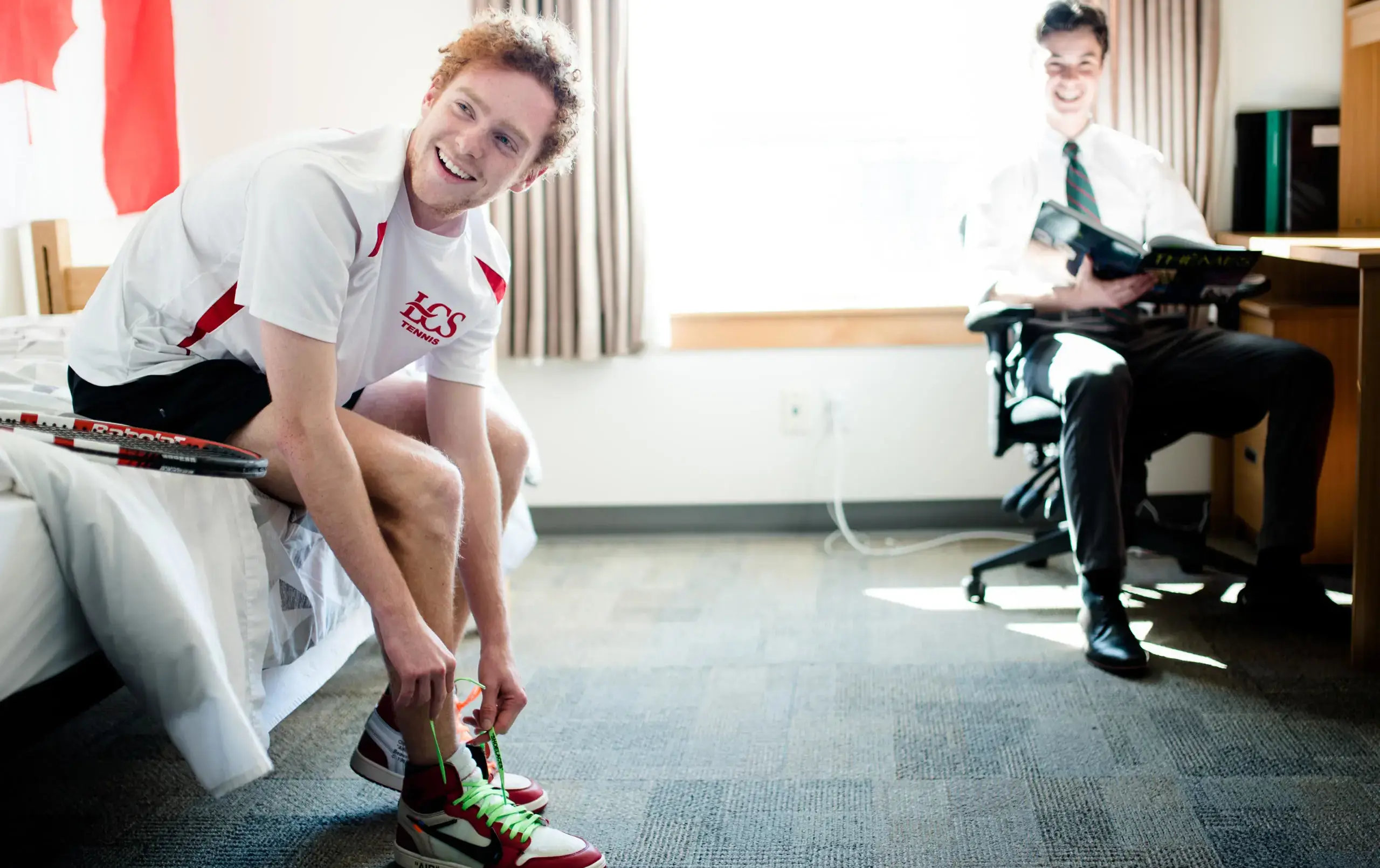 Two students getting ready in dorm room