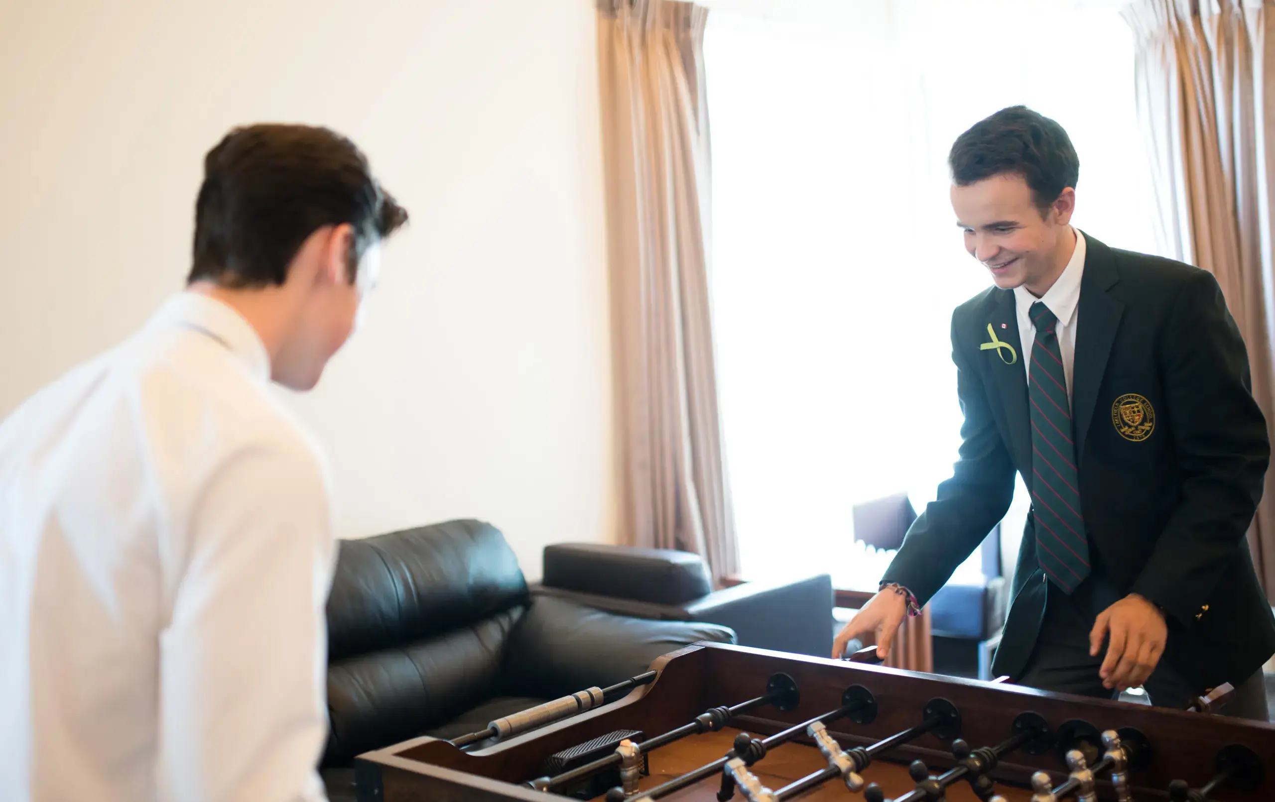 Two students playing foosball