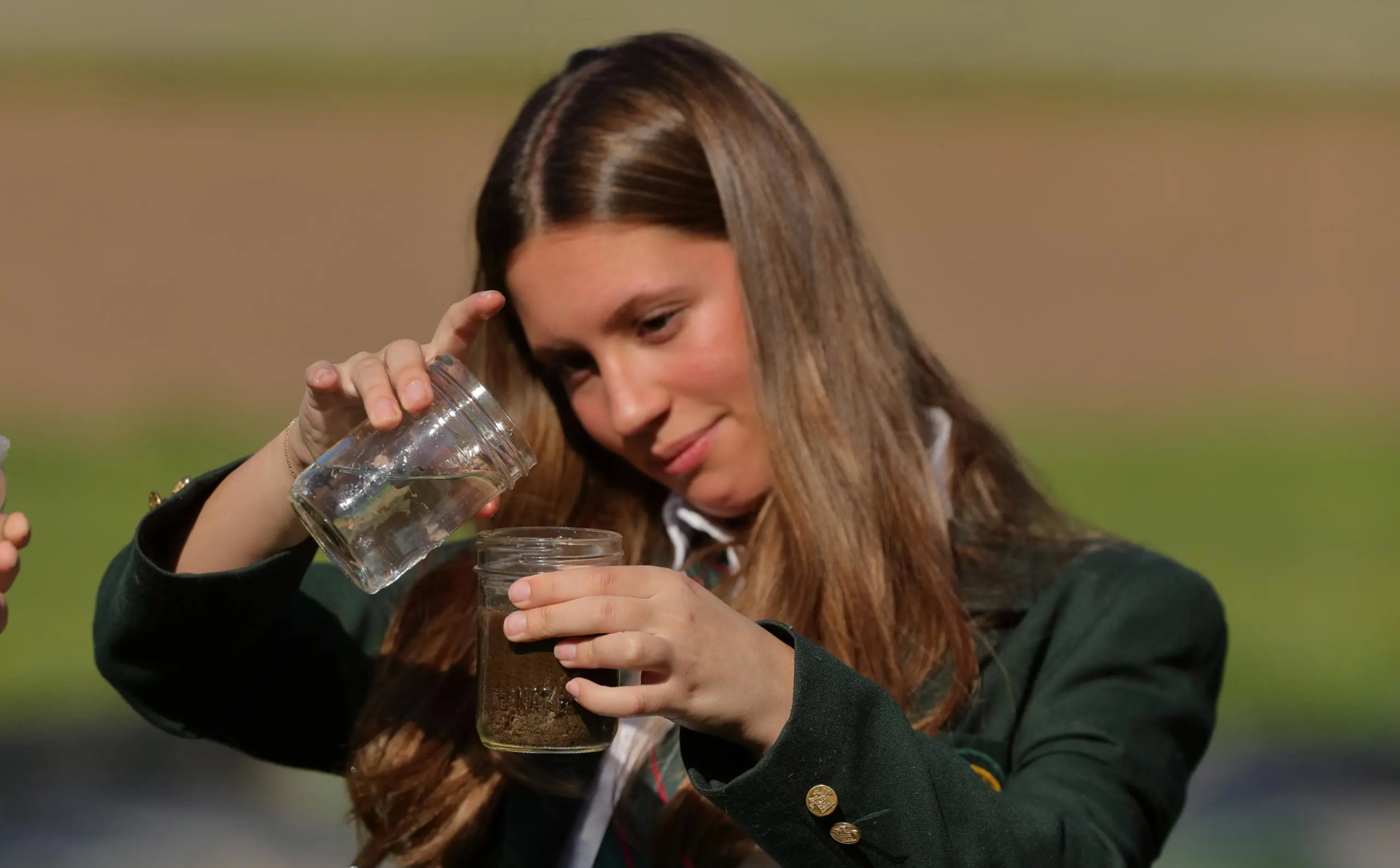 Student taking soil sample