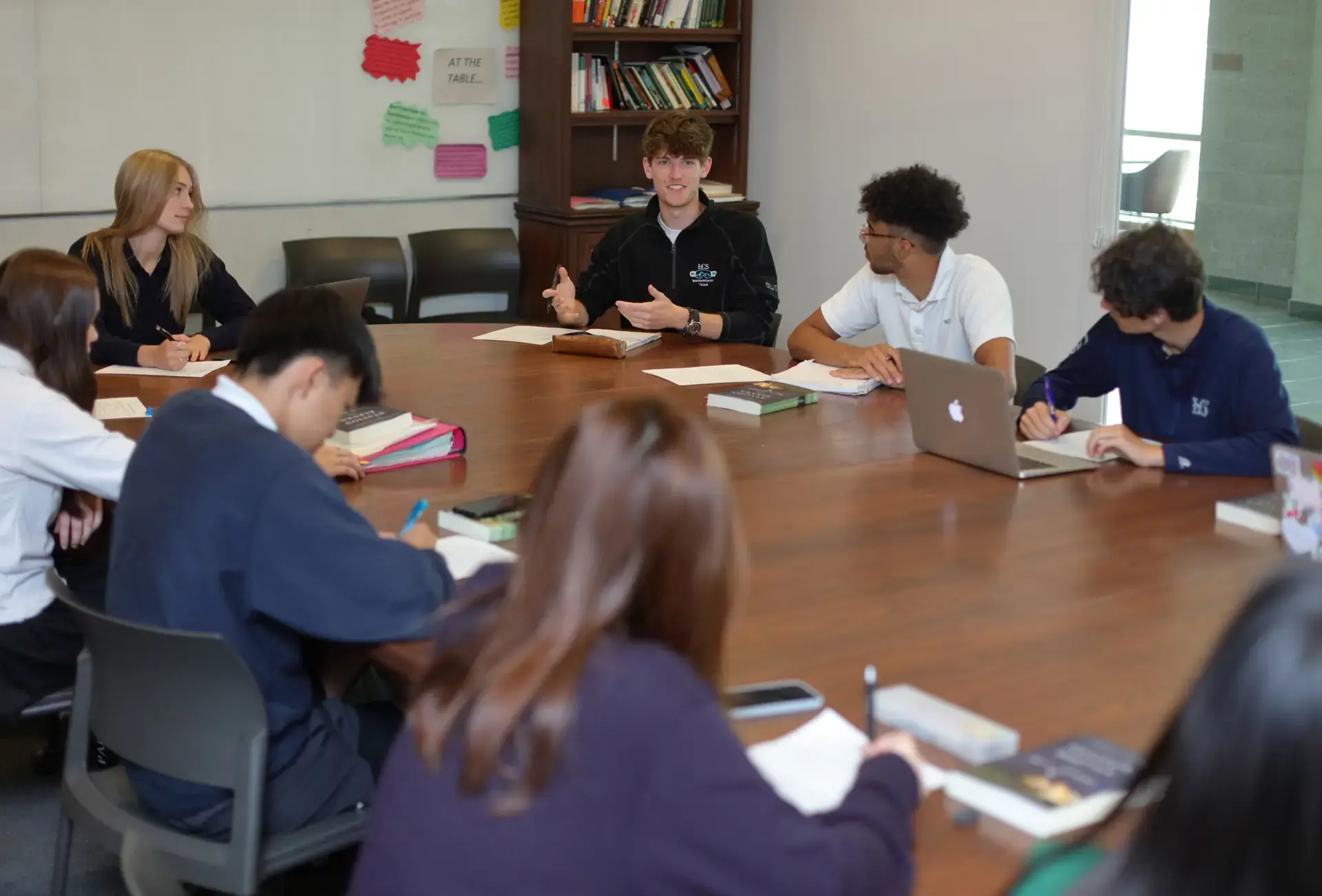 Students having a discussion around a large table
