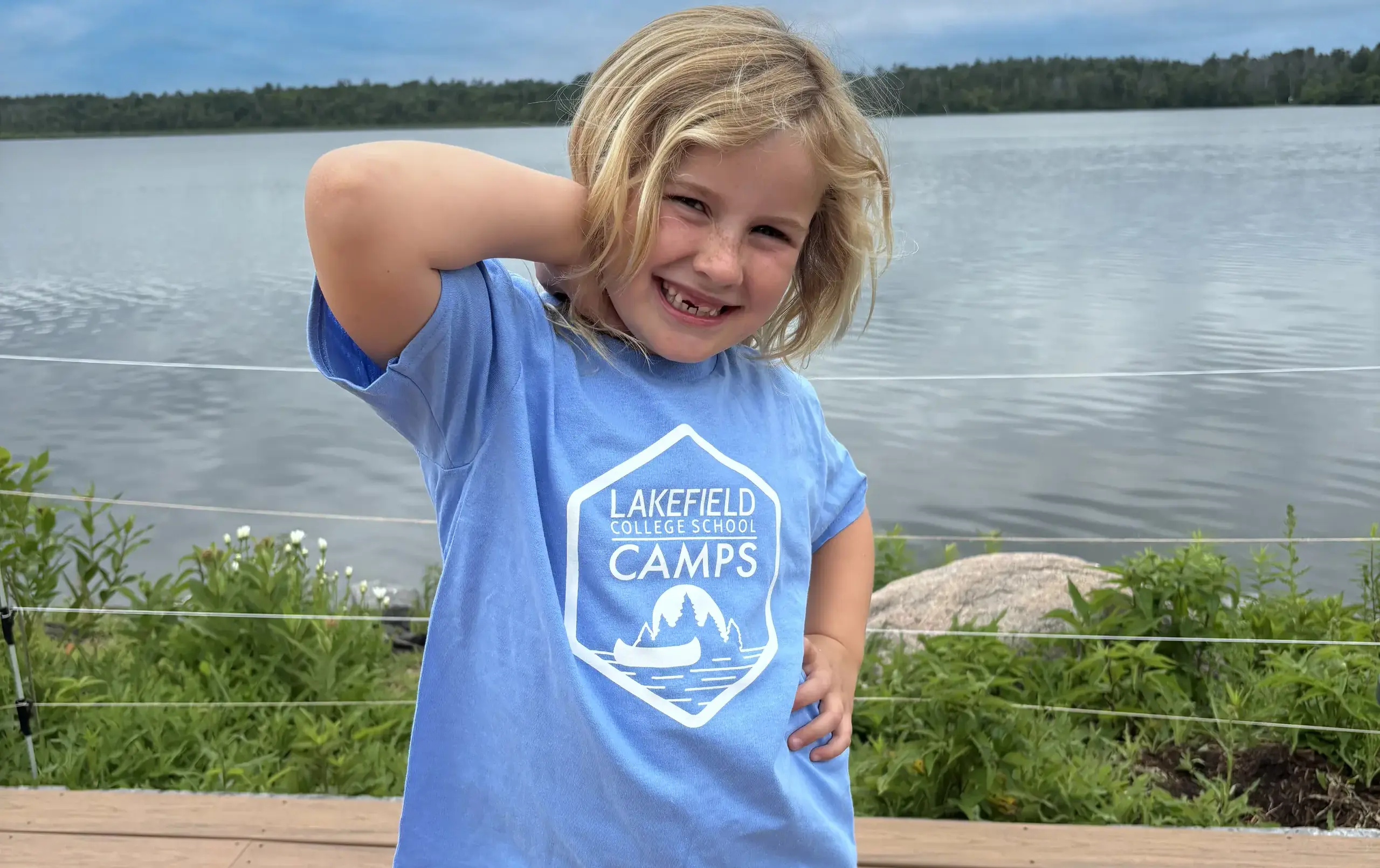 LCS Junior Day Camper posing with their annual blue camp shirt