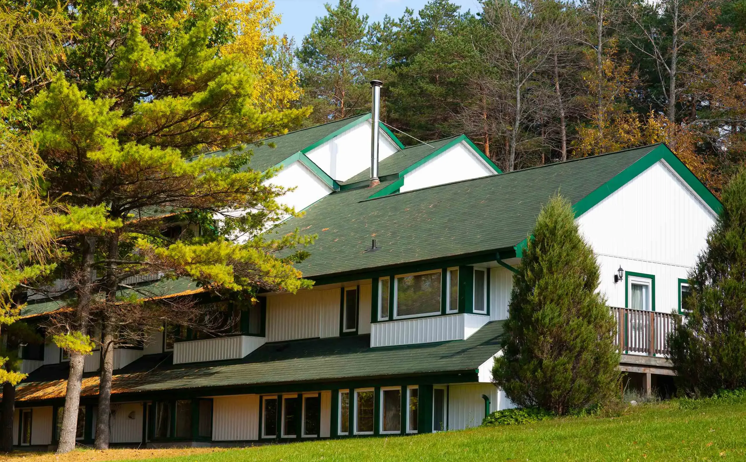 Exterior shot fo Ryder House, a white building with green trim