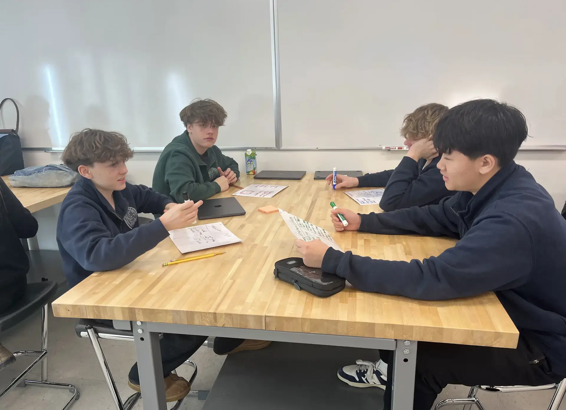 Students having a discussion at a desk