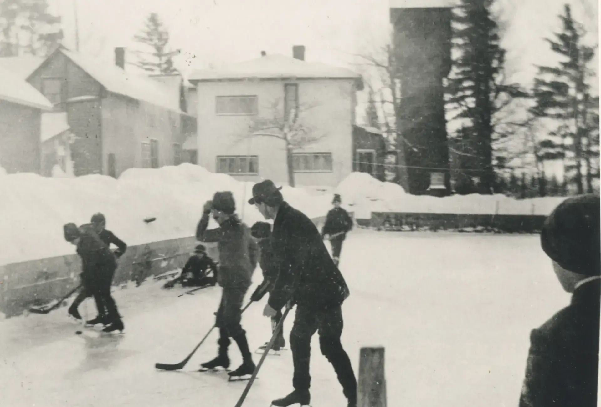 Archival photograph of Dr. Mackenzie and students skating