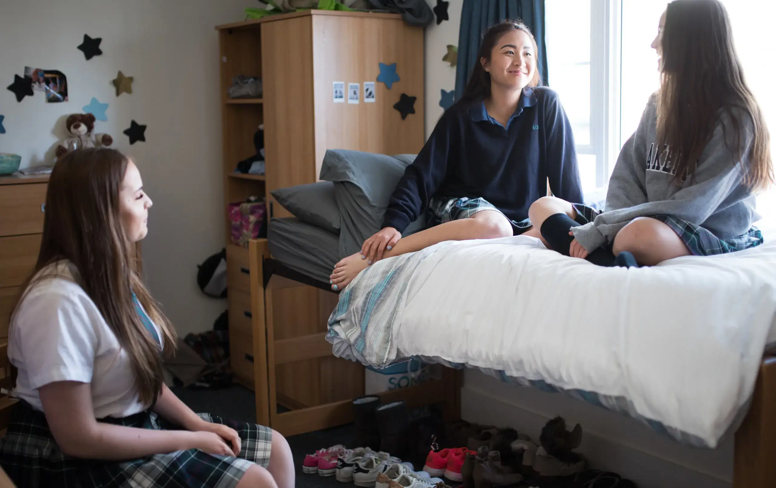 Three students relaxing in dorm room