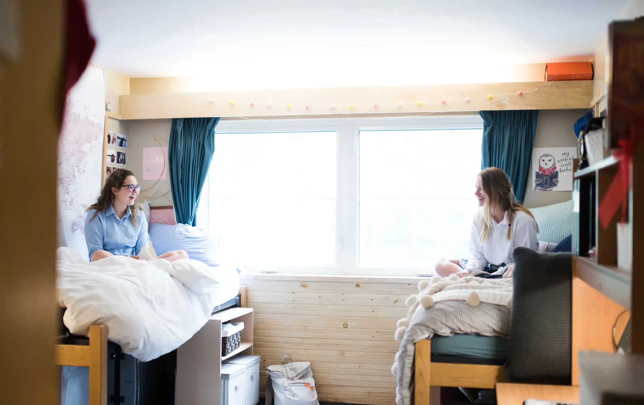 Students sitting on opposite bunks, chatting