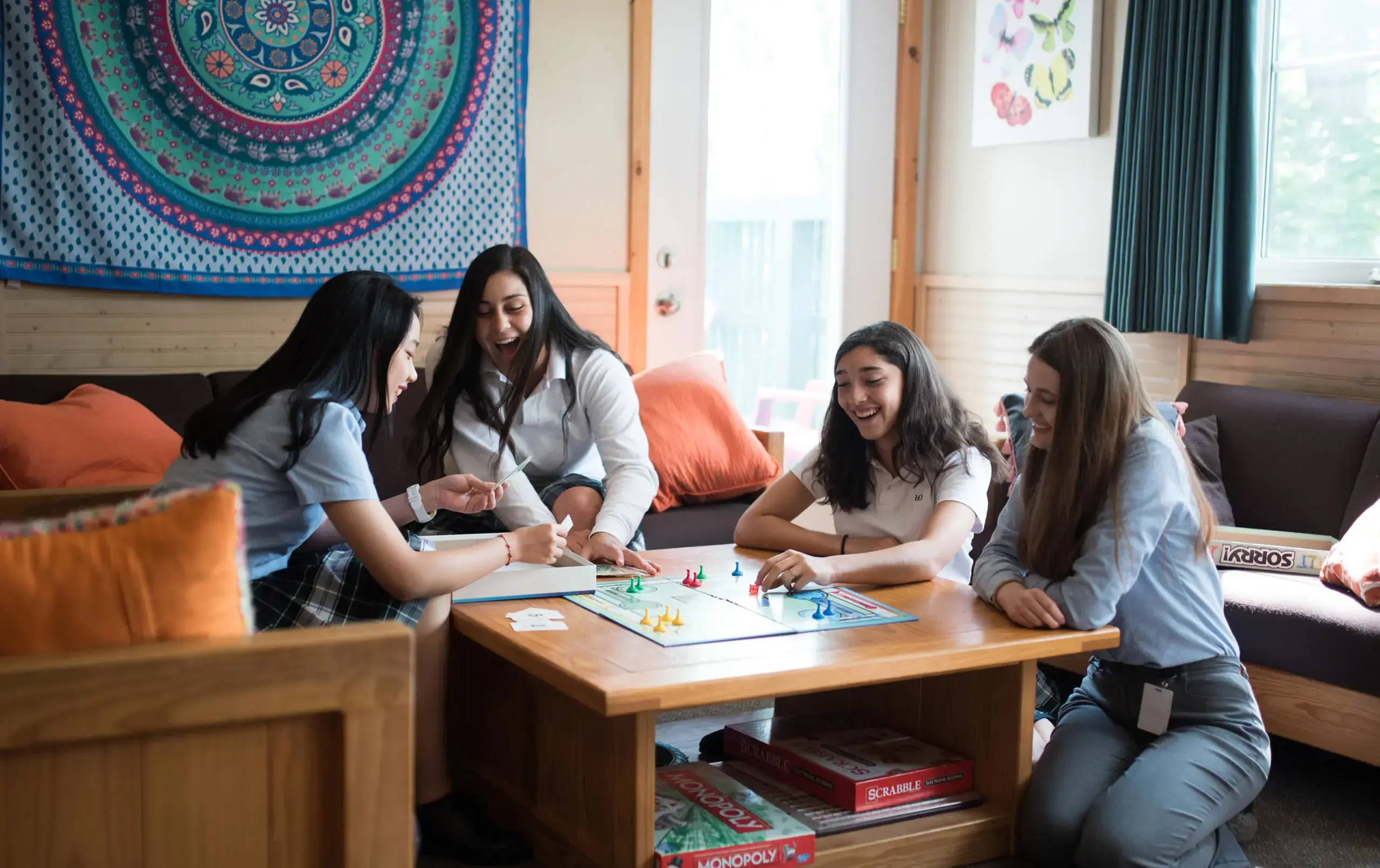 Students playing board game in common area