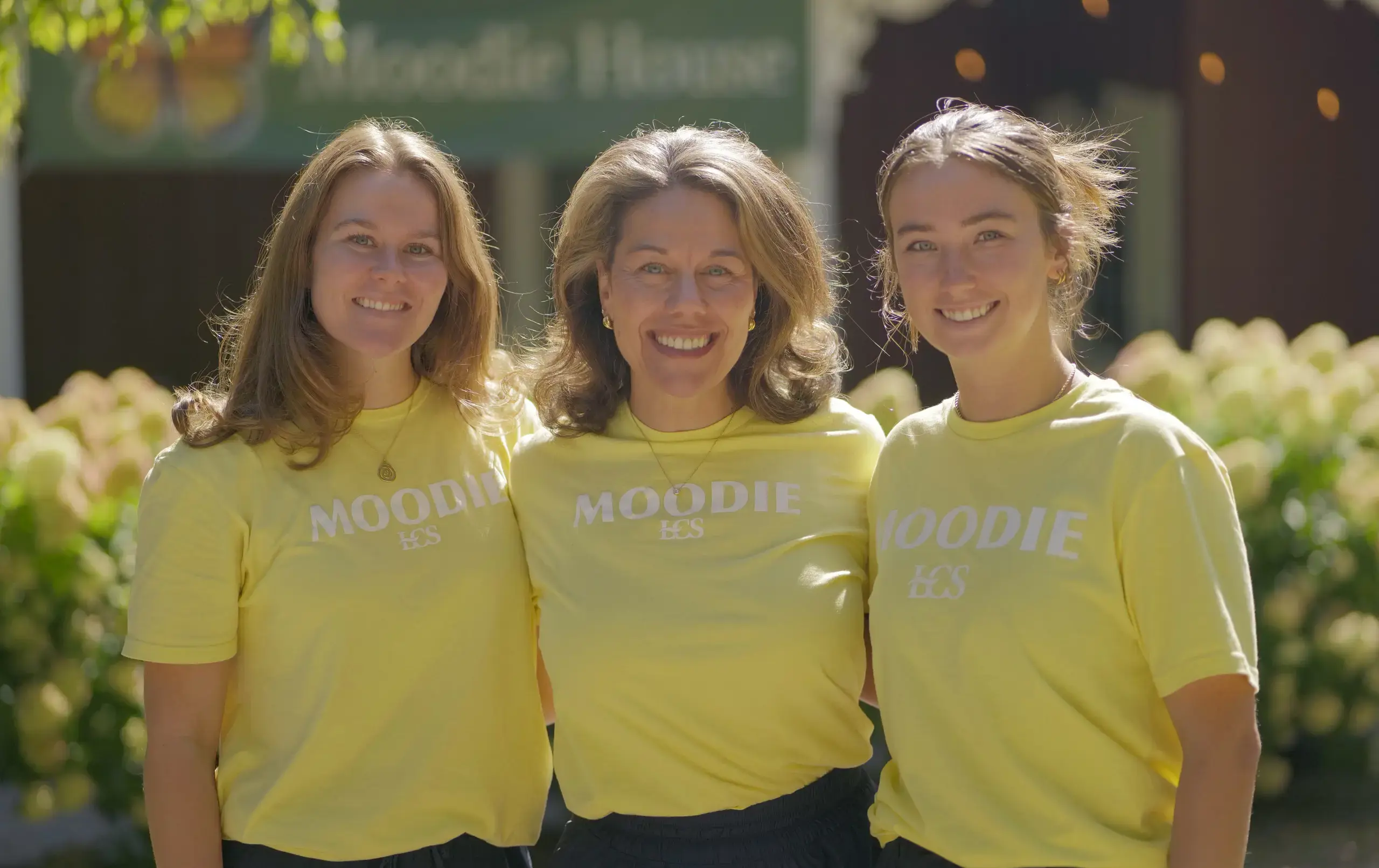 Moodie Team standing outside amongst the beautiful LCS trees