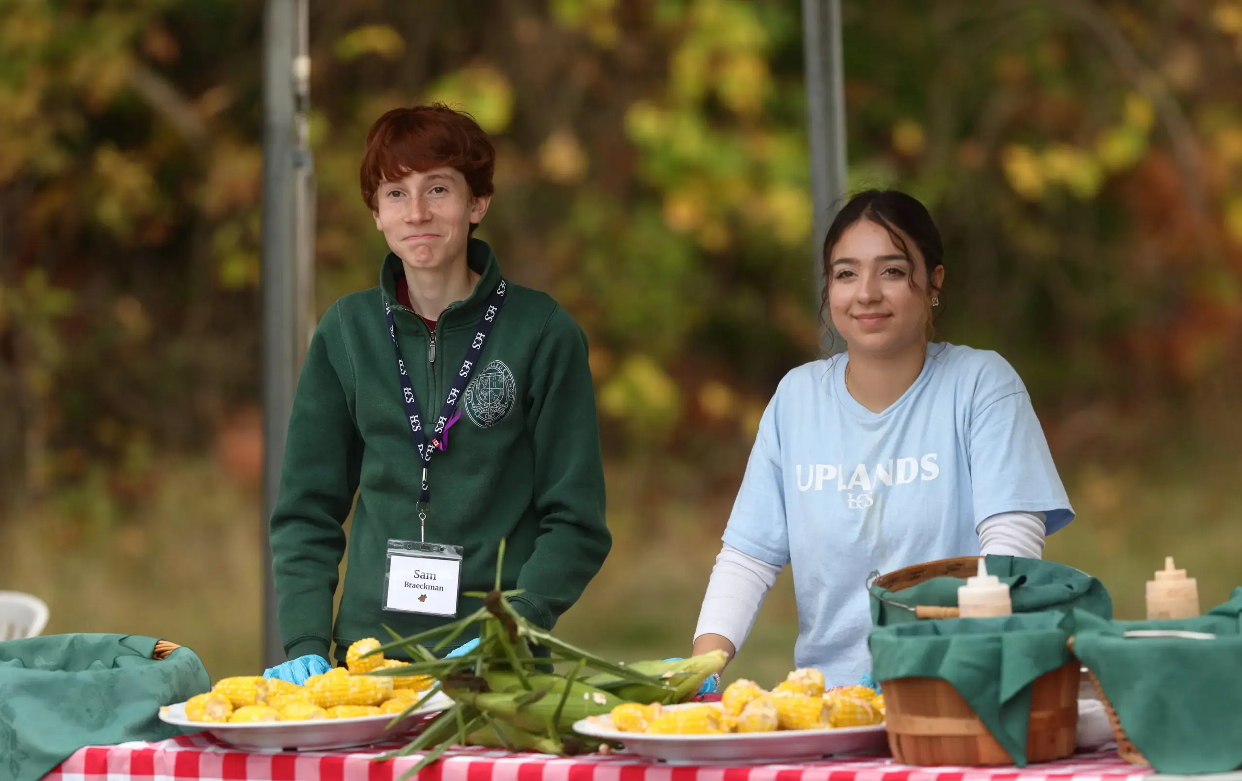 Students standing at table laden with produce