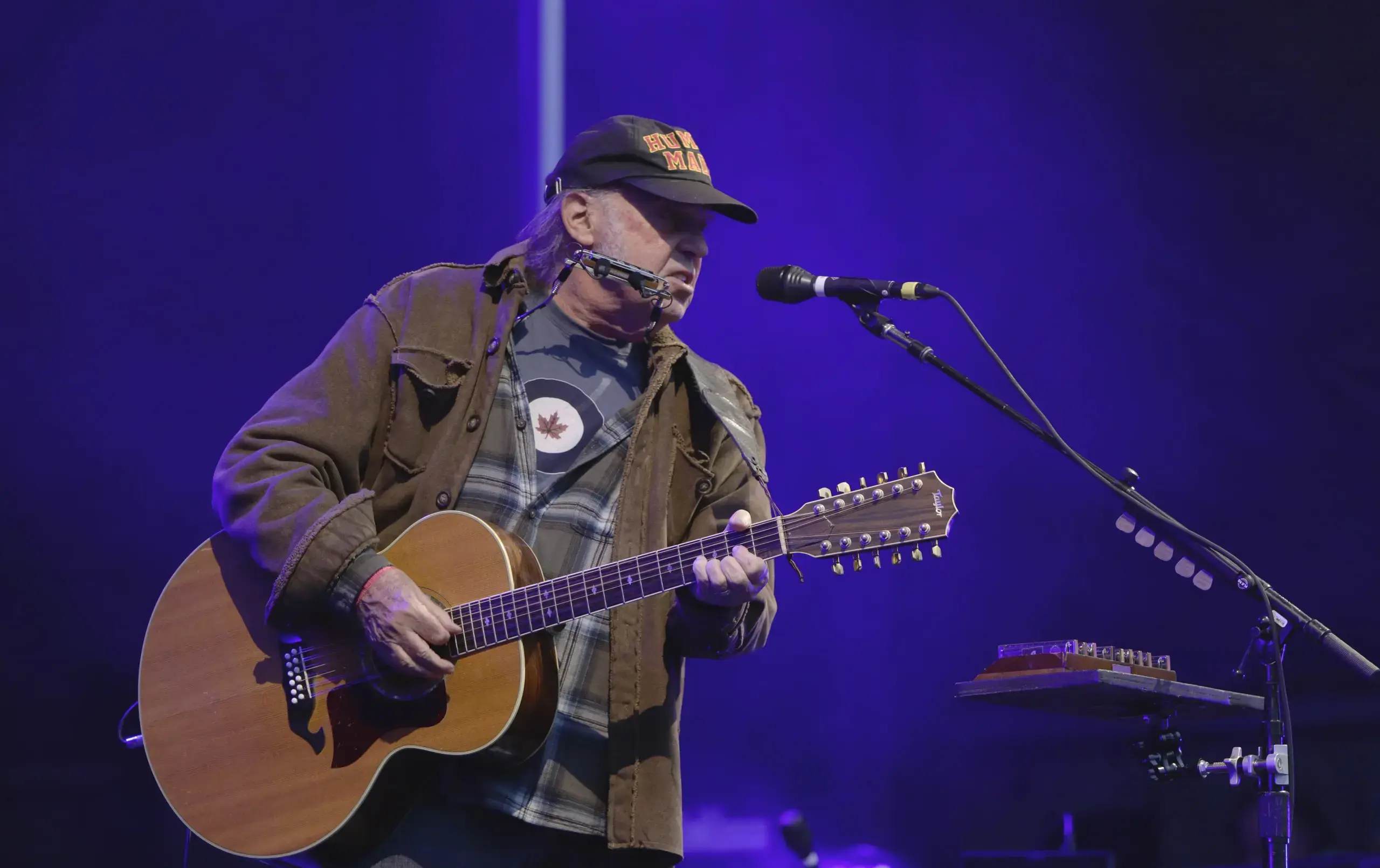 Neil Young playing guitar onstage