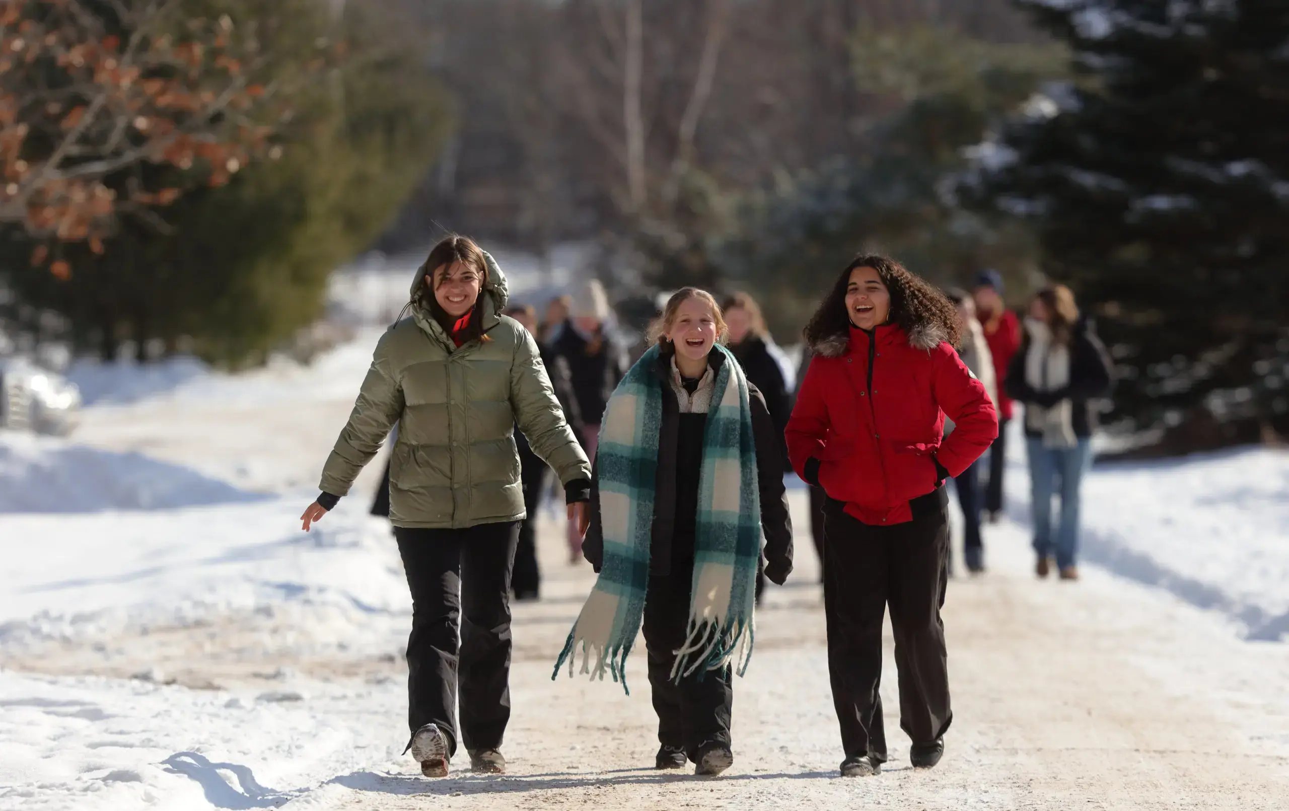 Students walkiing up path on snowy day