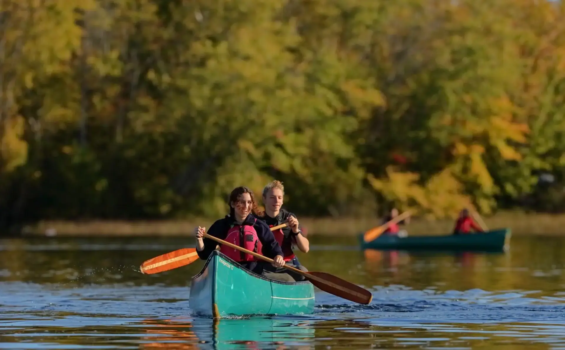 Students in a canoe paddling to Northcote to their overnight trip