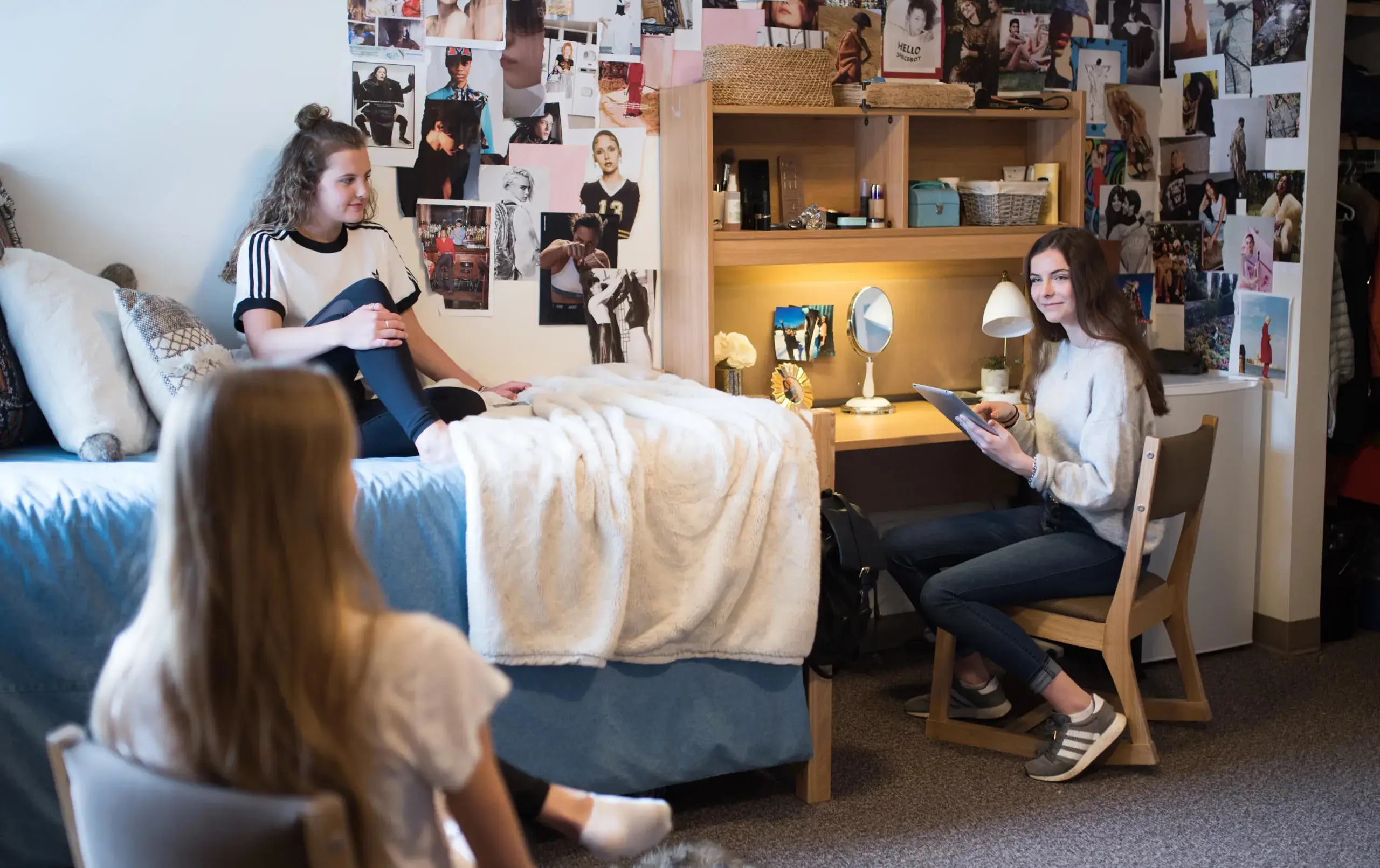Three students relaxing in dorm room