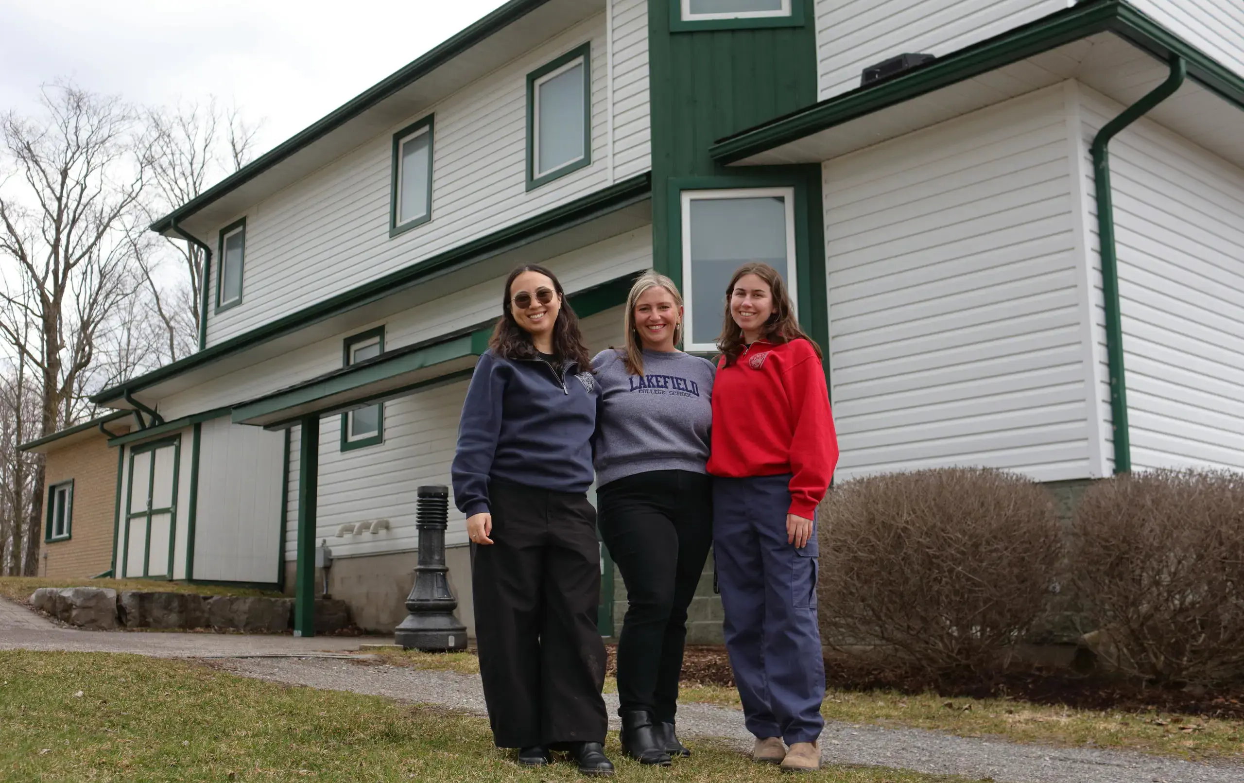 Ondaatje House team standing outside dormitory building