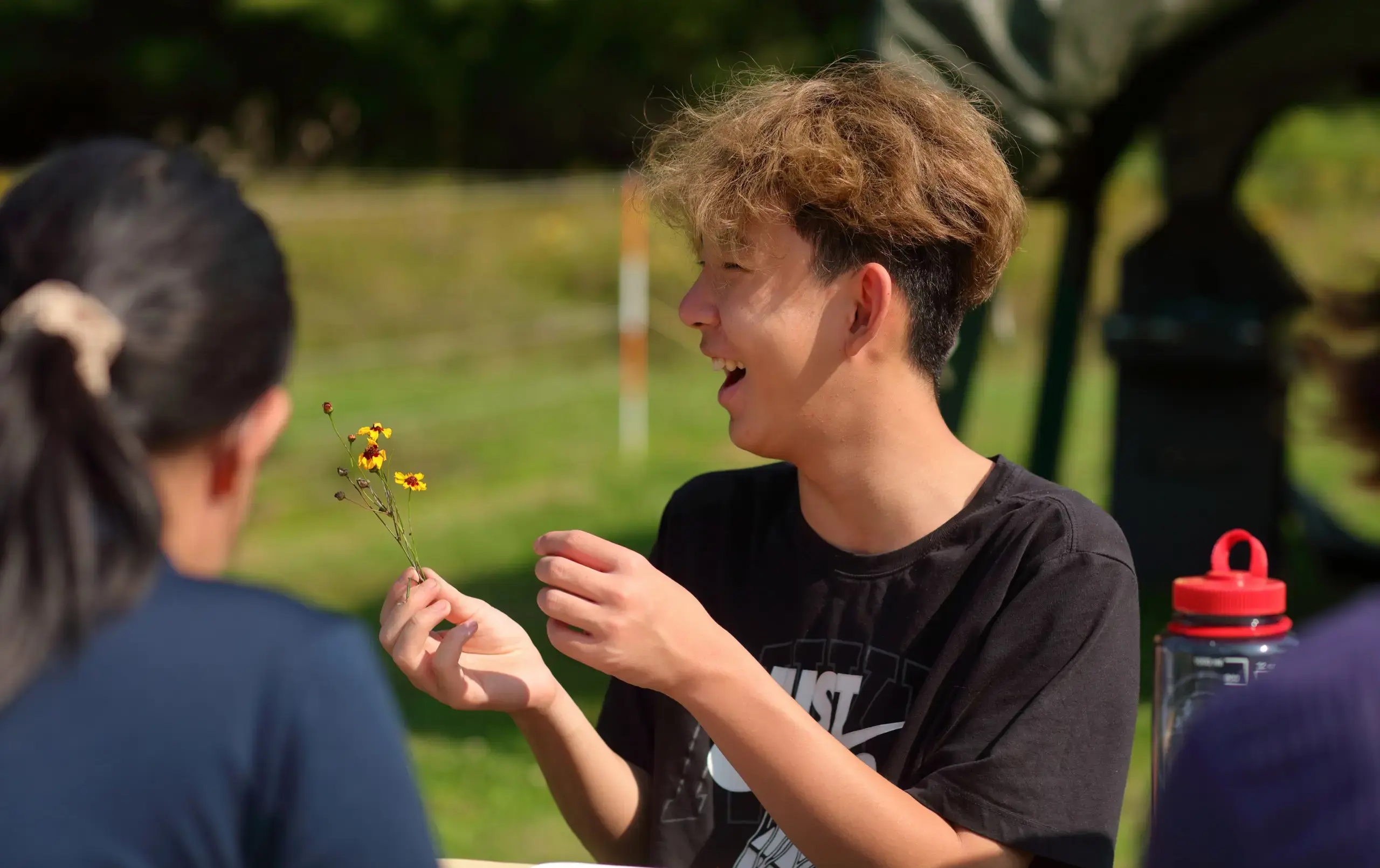 Student holding flower