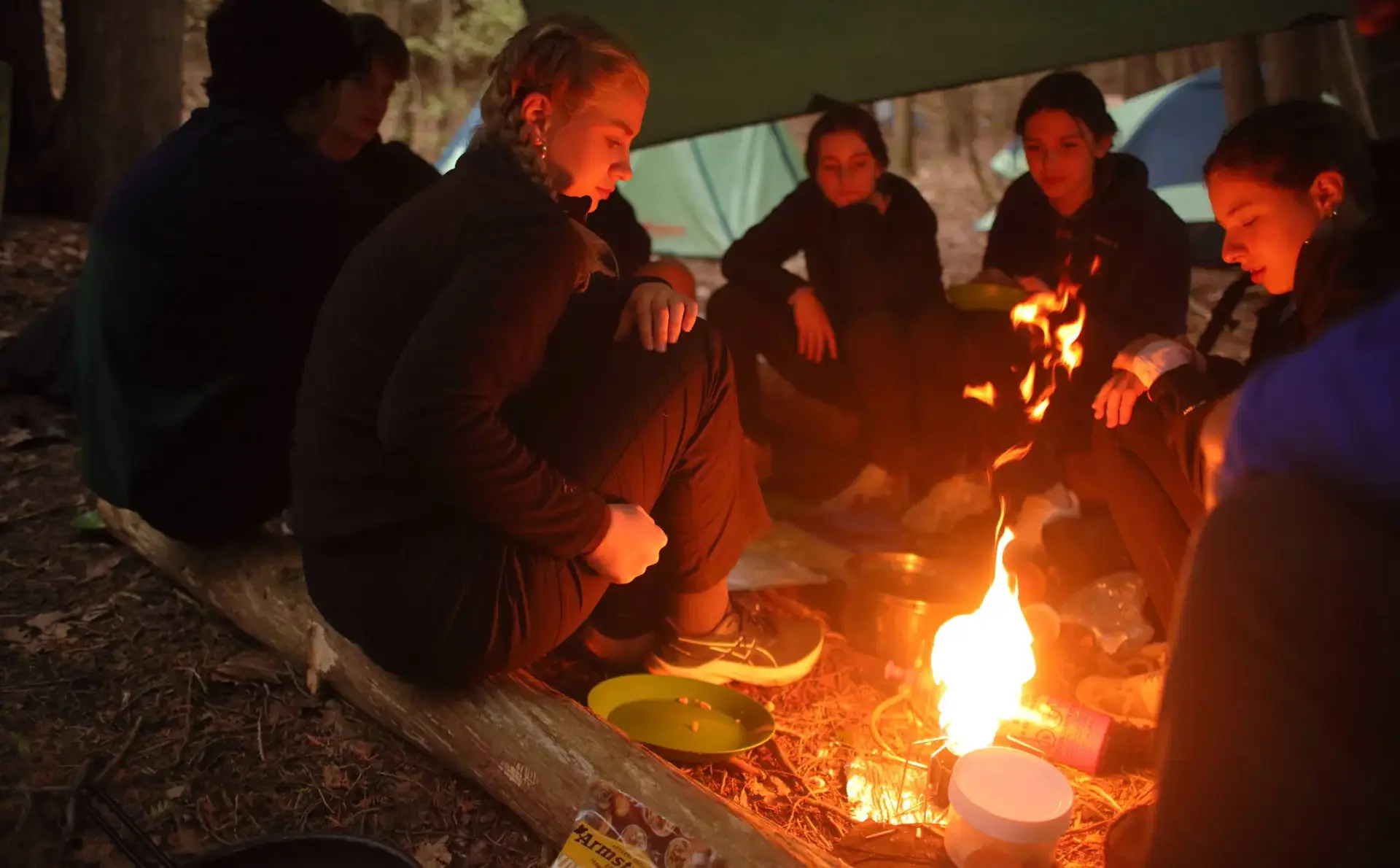 Students sitting around campfire
