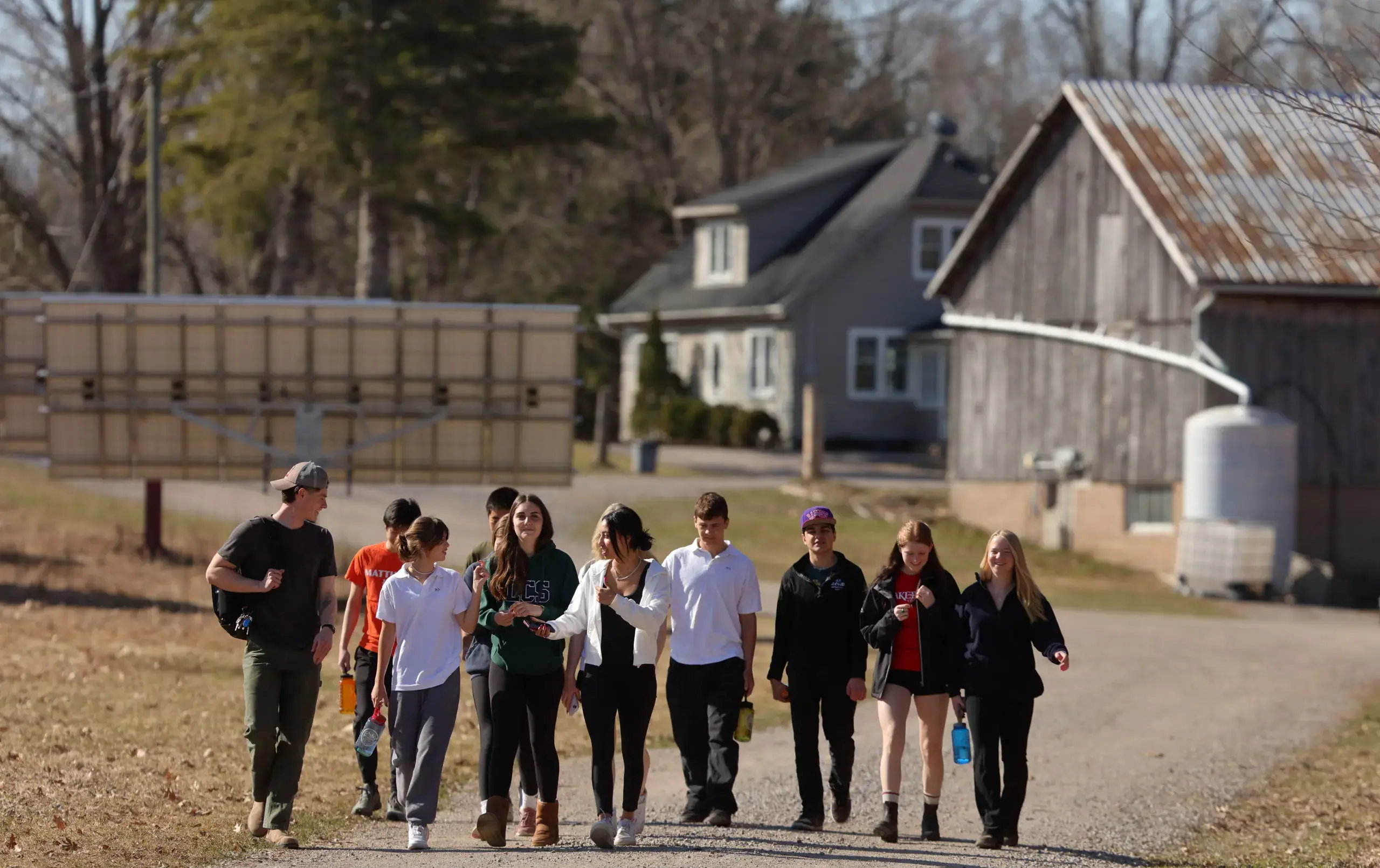 Students walking along the farm trails from main farm building